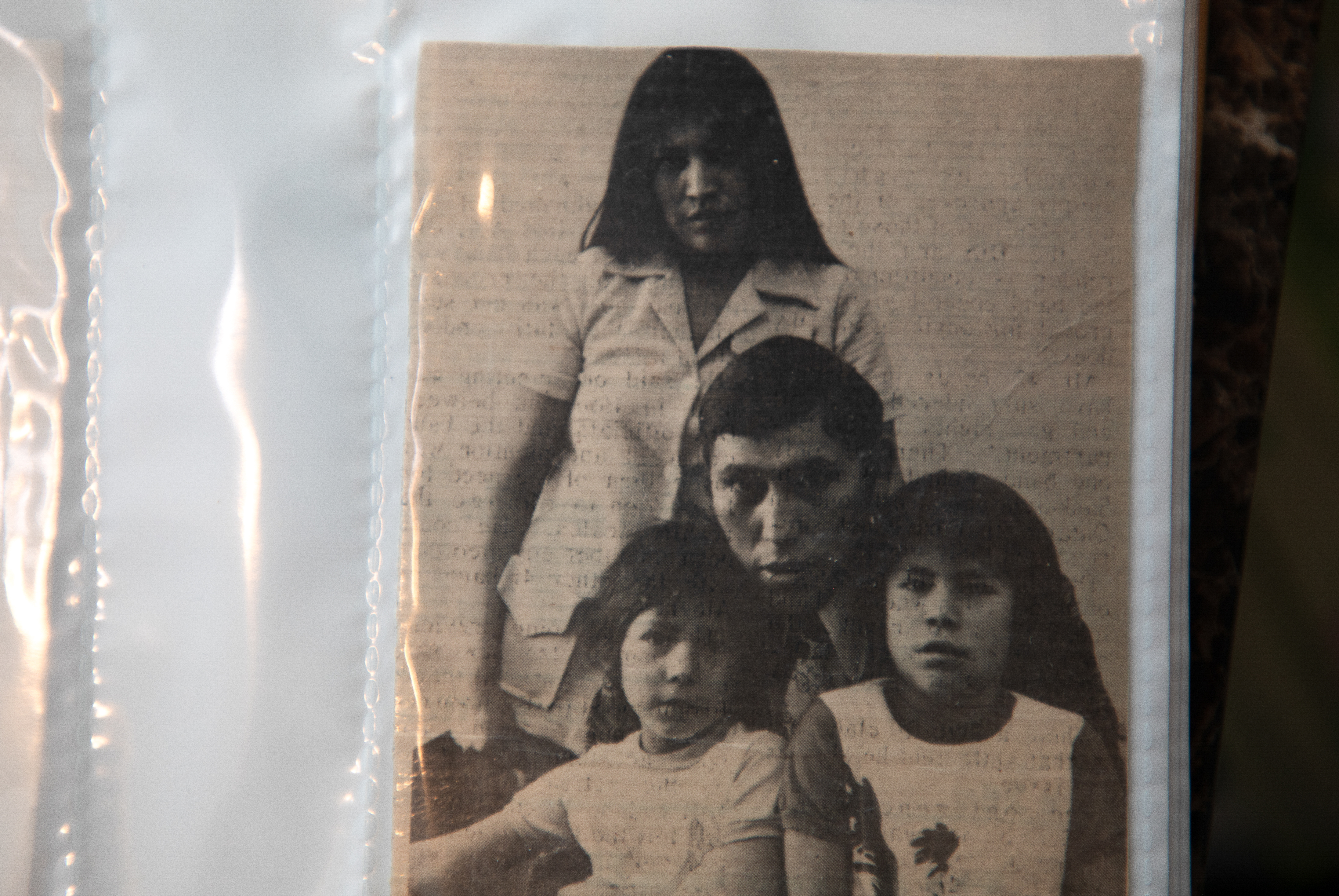 A black and white photo shows a woman, a man and two children