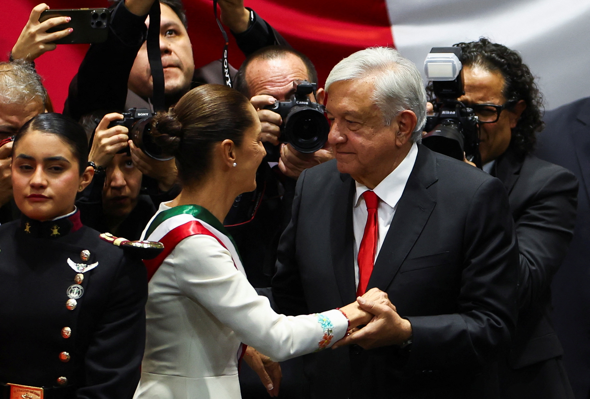 Mexico's new President Claudia Sheinbaum speaks with outgoing President Andres Manuel Lopez Obrador during her swearing-in ceremony at Congress, in Mexico City, Mexico, October 1, 2024 [Raquel Cunha/Reuters]