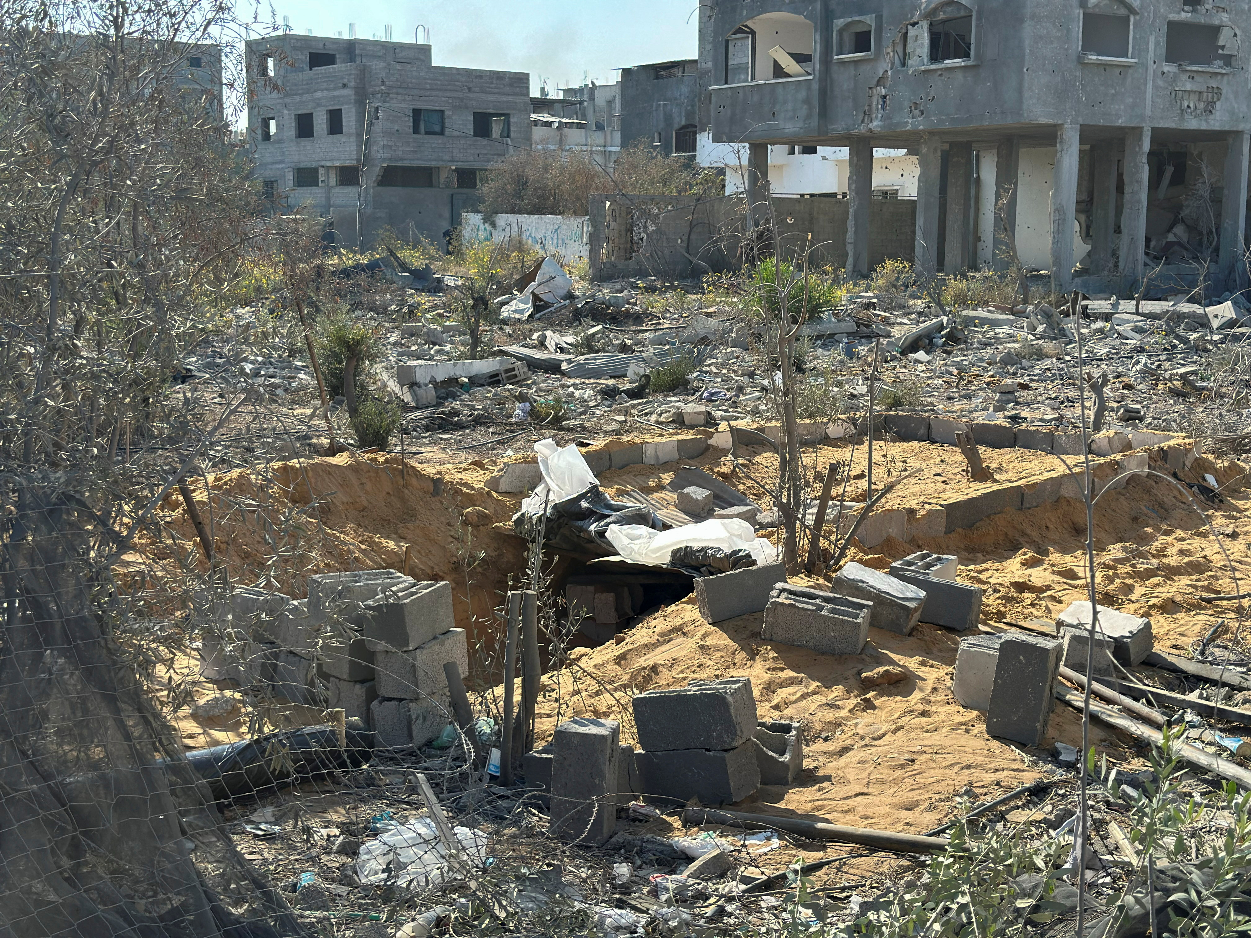 A mass grave in a yard is prepared for the burial of Palestinians killed in Israeli strikes, amid the Israel-Hamas conflict, in Beit Lahiya in the northern Gaza Strip, November 5