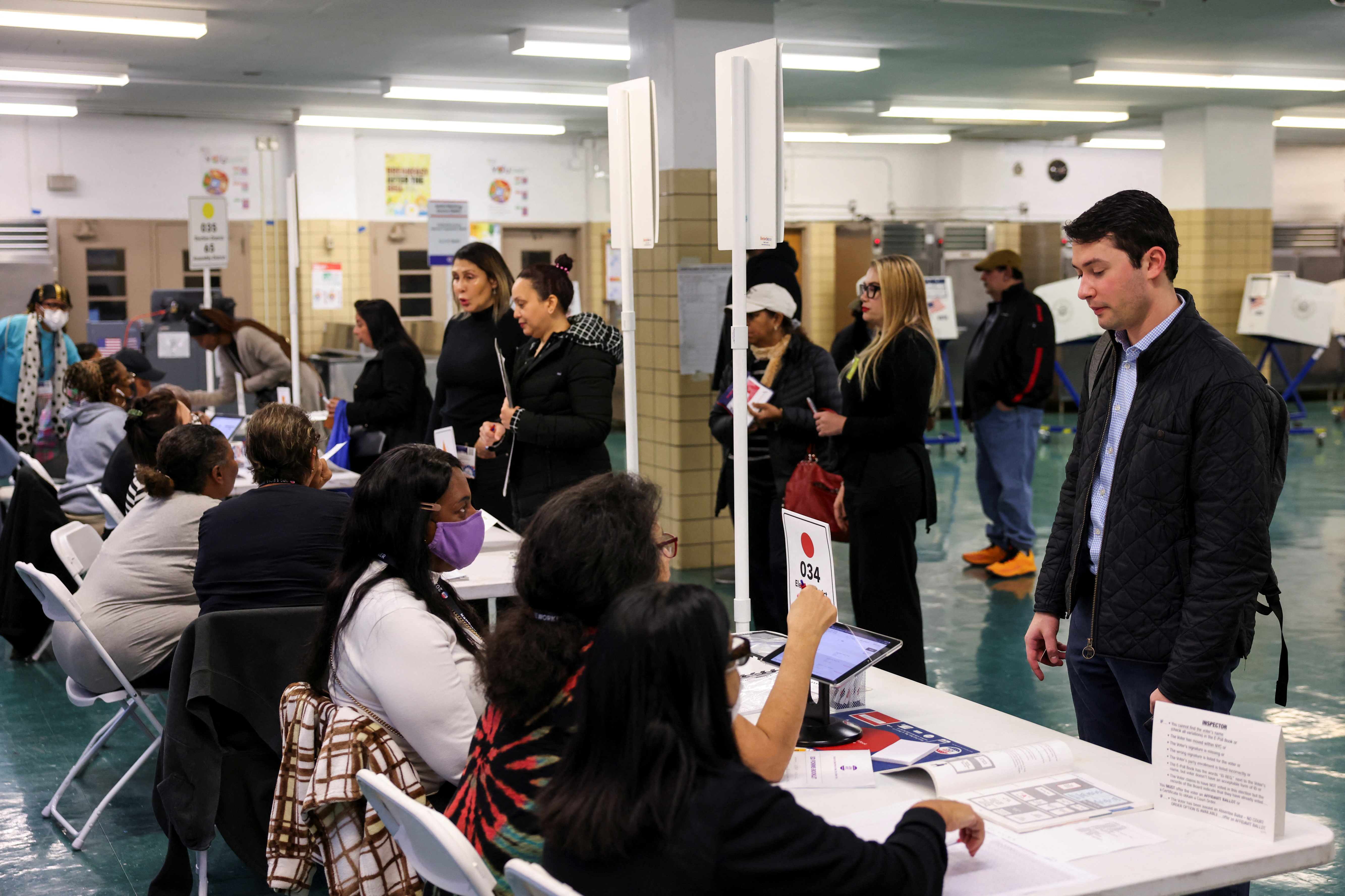 People gather at P.S. 140 Nathan Straus Elementary School to vote for the 2024 U.S. presidential election, on Election Day in Manhattan, New York City, U.S., November 5