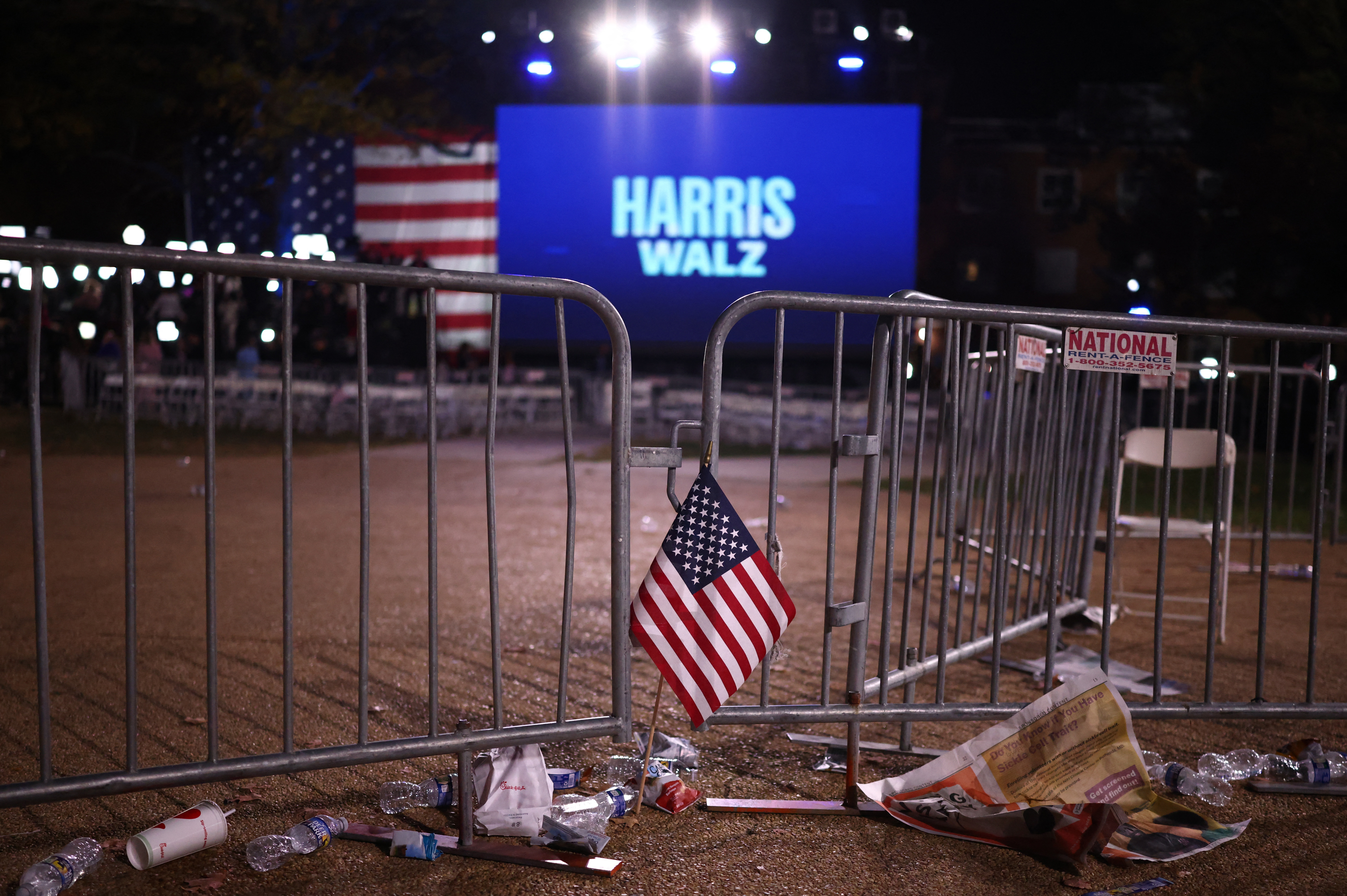 A U.S. flag is left by a barrier at the Election Night rally for Democratic presidential nominee U.S. Vice President Kamala Harris at Howard University, in Washington, U.S., November 6, 2024. REUTERS/Daniel Cole