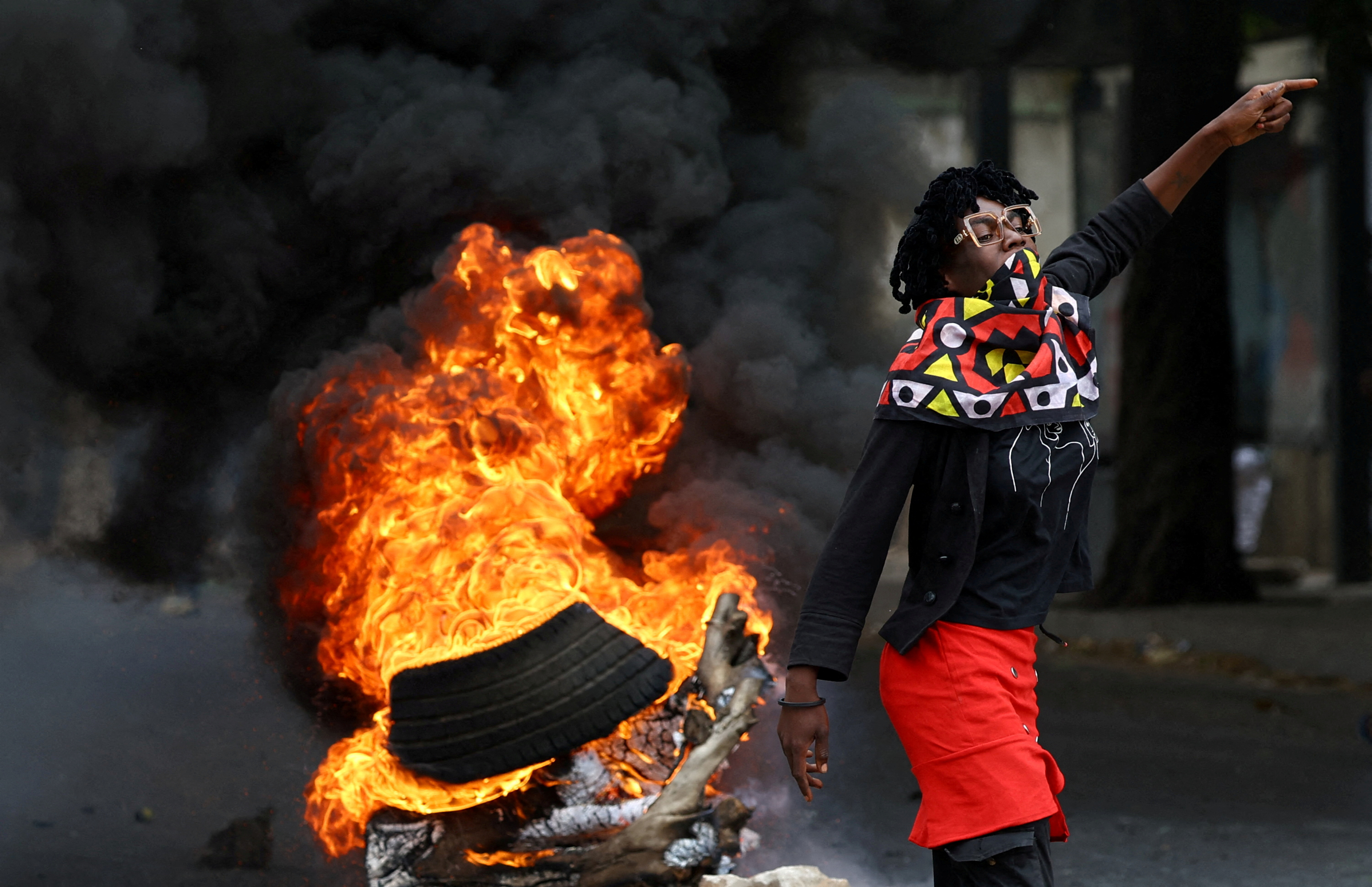 A protester reacts near a burning barricade during a "national shutdown" against the election outcome, at Luis Cabral township in Maputo, Mozambique, November 7, 2024. REUTERS/Siphiwe Sibeko TPX IMAGES OF THE DAY