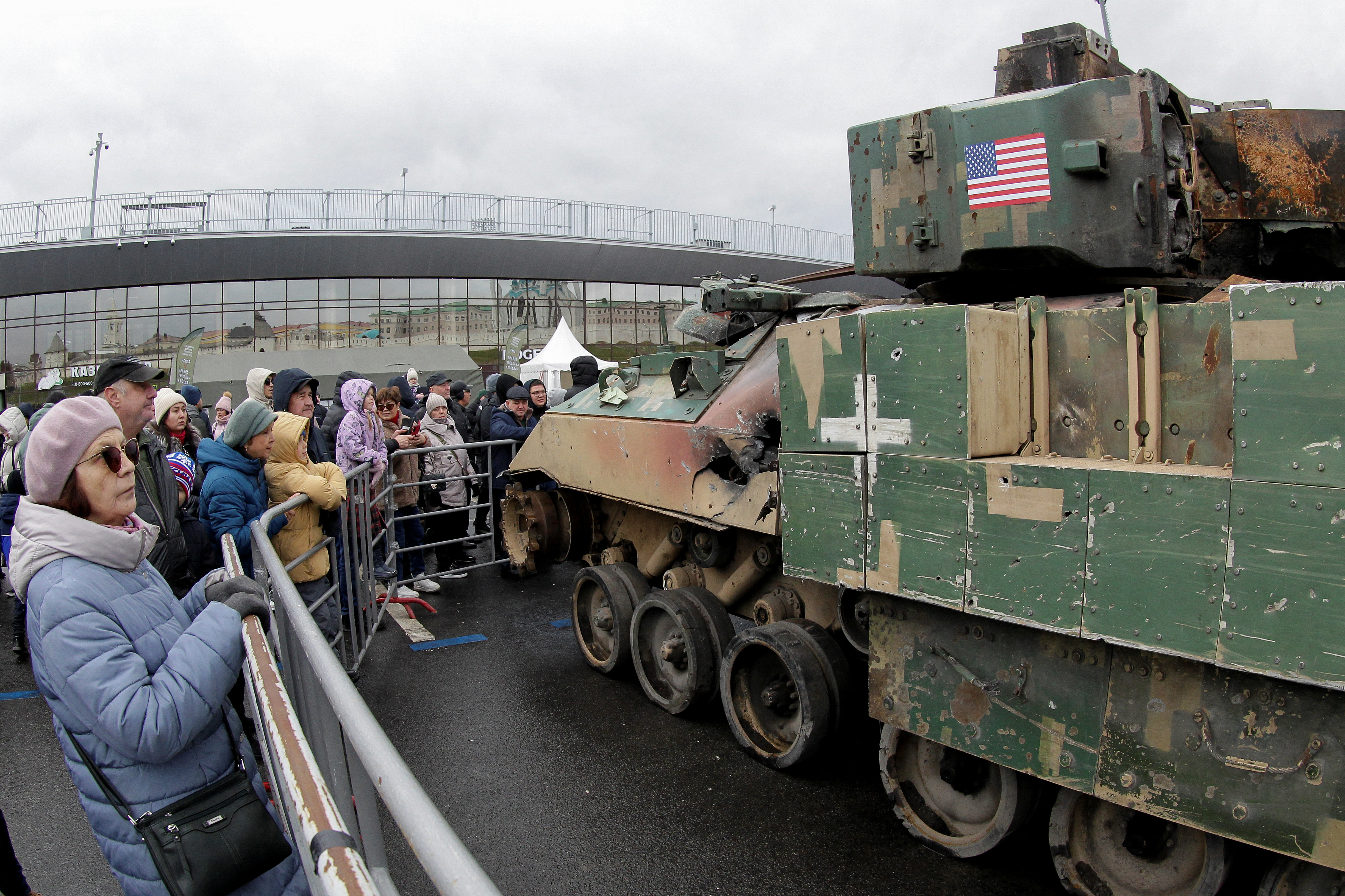 People gather near a Bradley fighting vehicle at an exhibition of Ukrainian troops' weaponry and hardware, which according to organizers were captured by the Russian army in the course of a military conflict with Ukraine, in Kazan, Russia