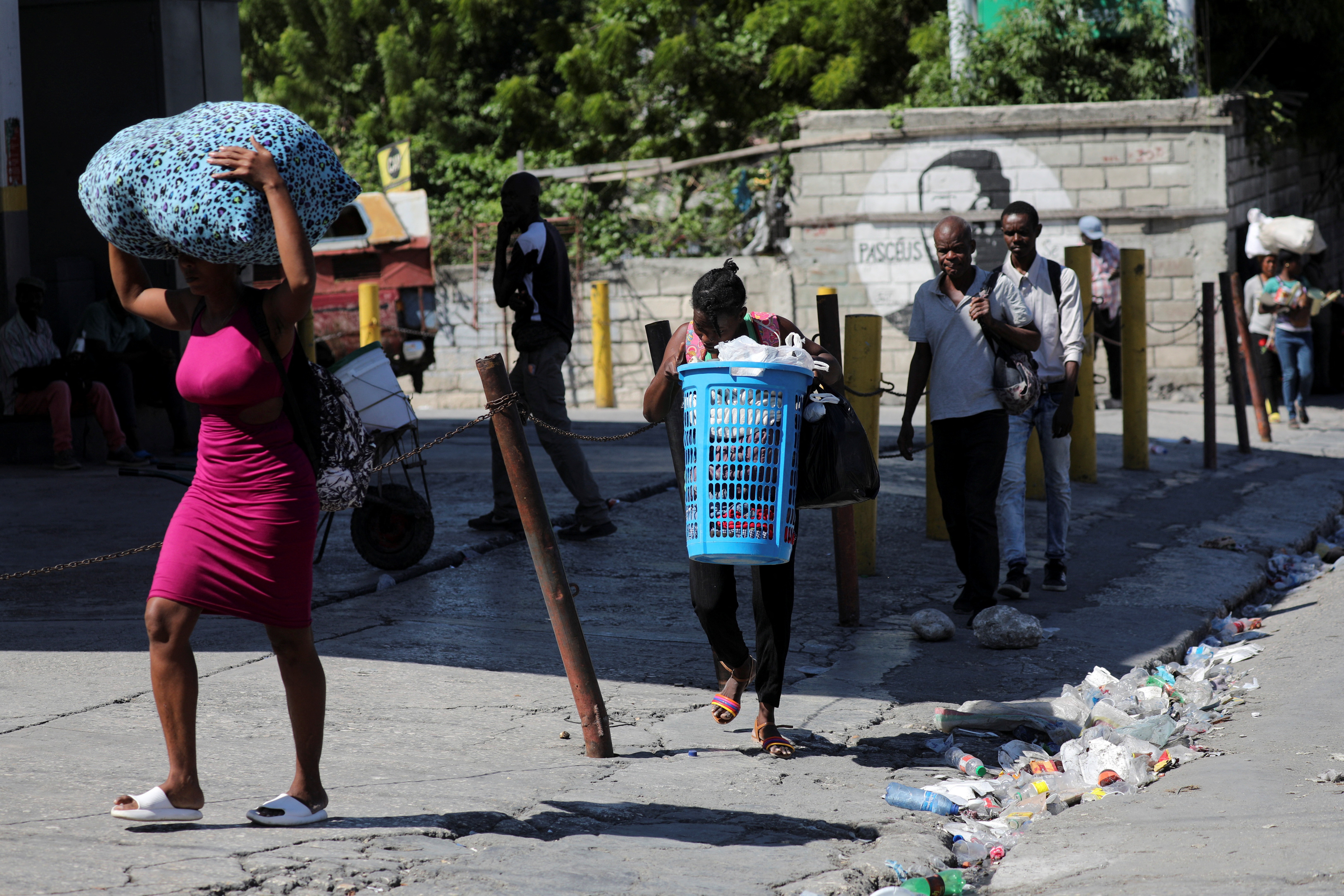 People carry their belongings after fleeing their homes amid gang violence in Port-au-Prince, Haiti