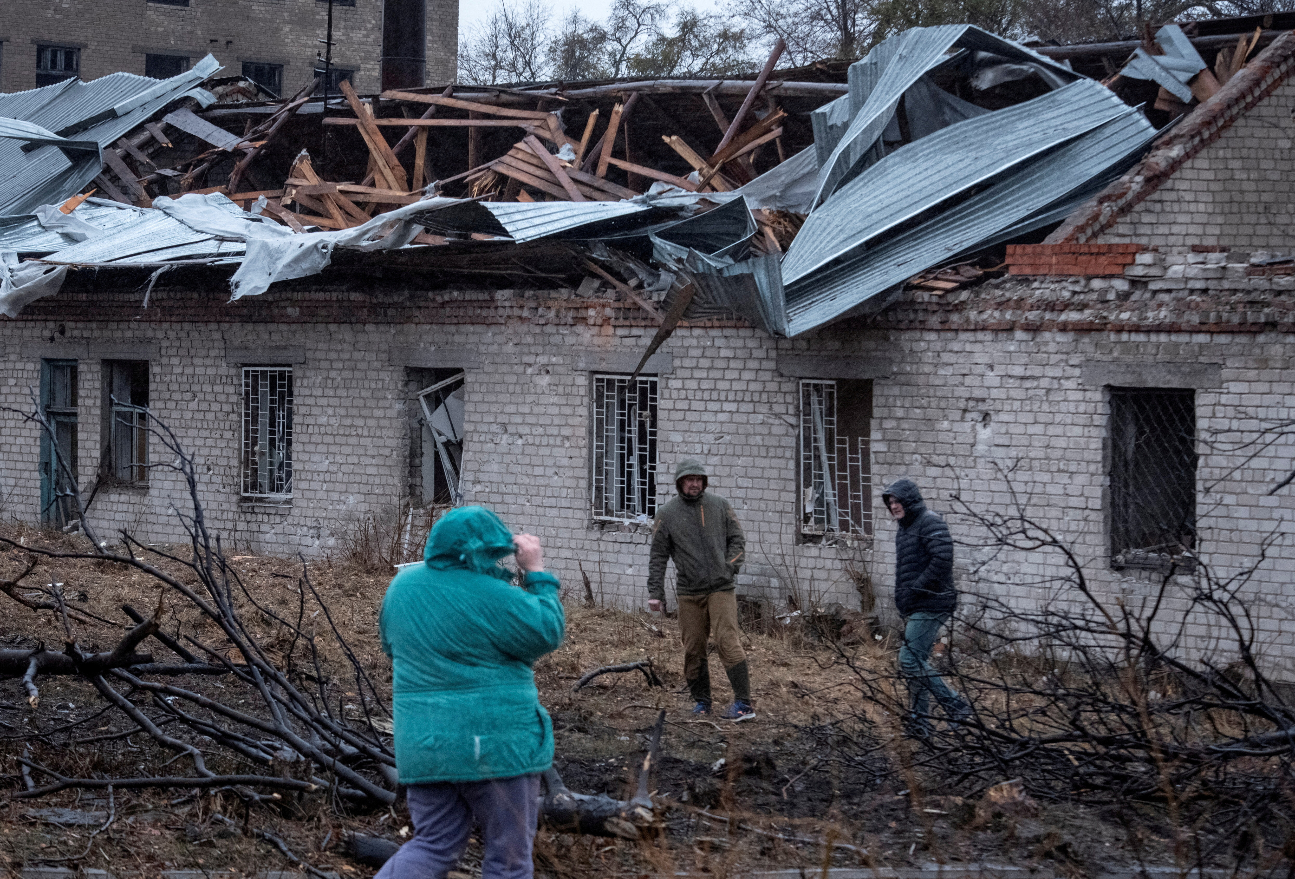 FILE PHOTO: Residents walk at a site of a Russian missile strike, amid Russia's attack on Ukraine, in Dnipro, Ukraine November 21, 2024. REUTERS/Mykola Synelnykov TPX IMAGES OF THE DAY/File Photo