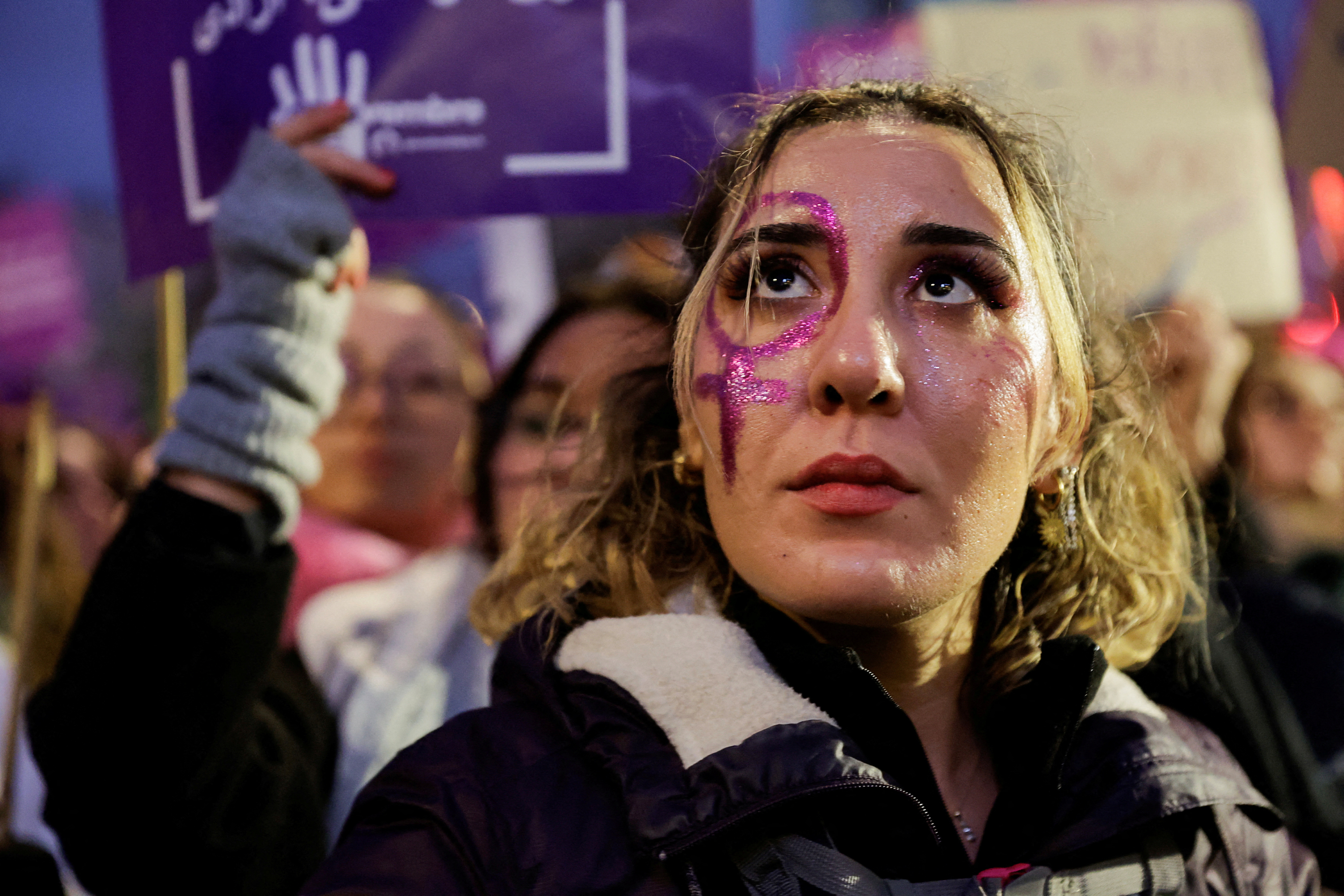 A woman looks on, as people attend a demonstration to protest against femicide, sexual violence and all gender-based violence to mark the International Day for Elimination of Violence Against Women, in Paris on November 23, 2024. [Abdul Saboor/Reuters]
