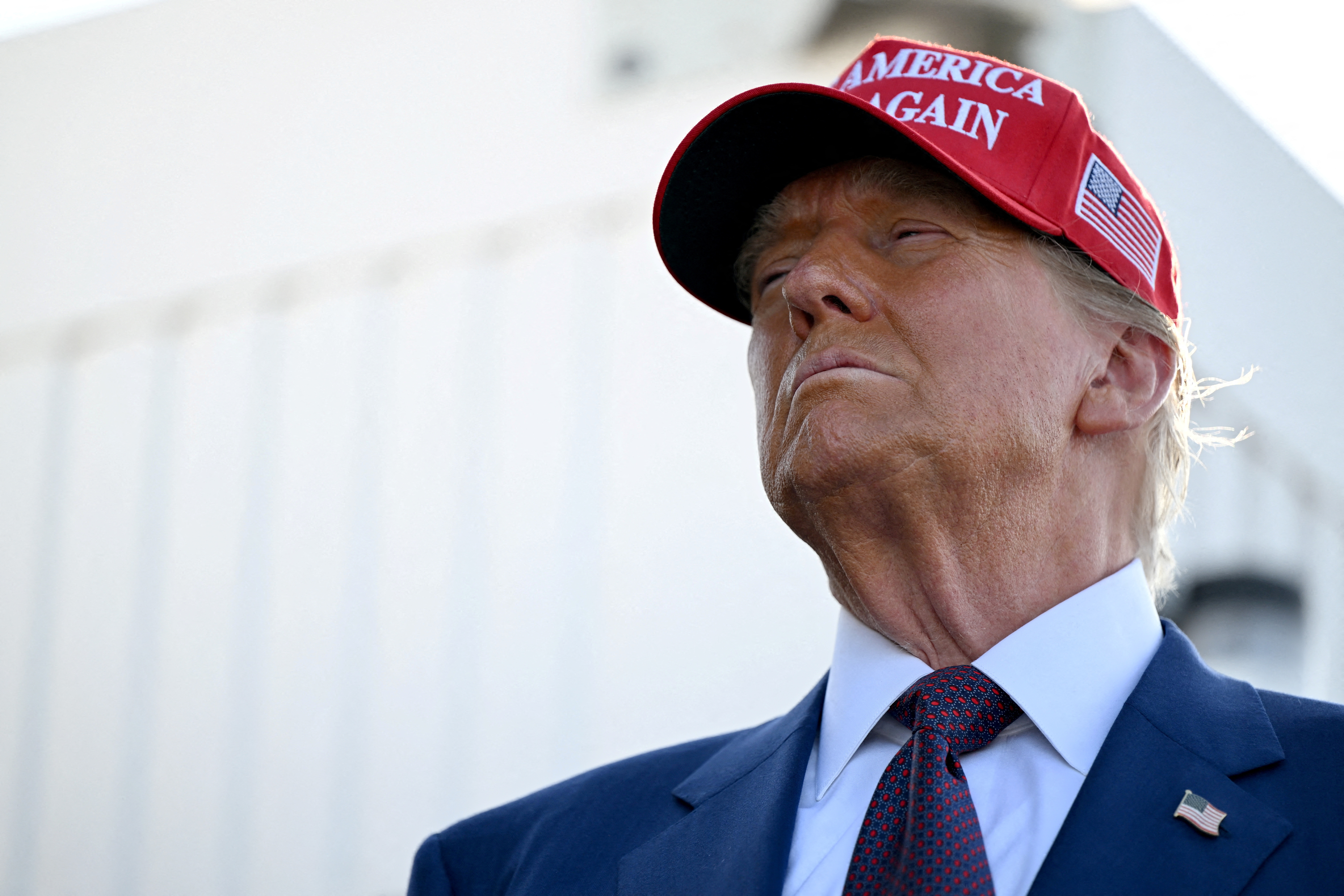 Donald Trump in a red MAGA cap.