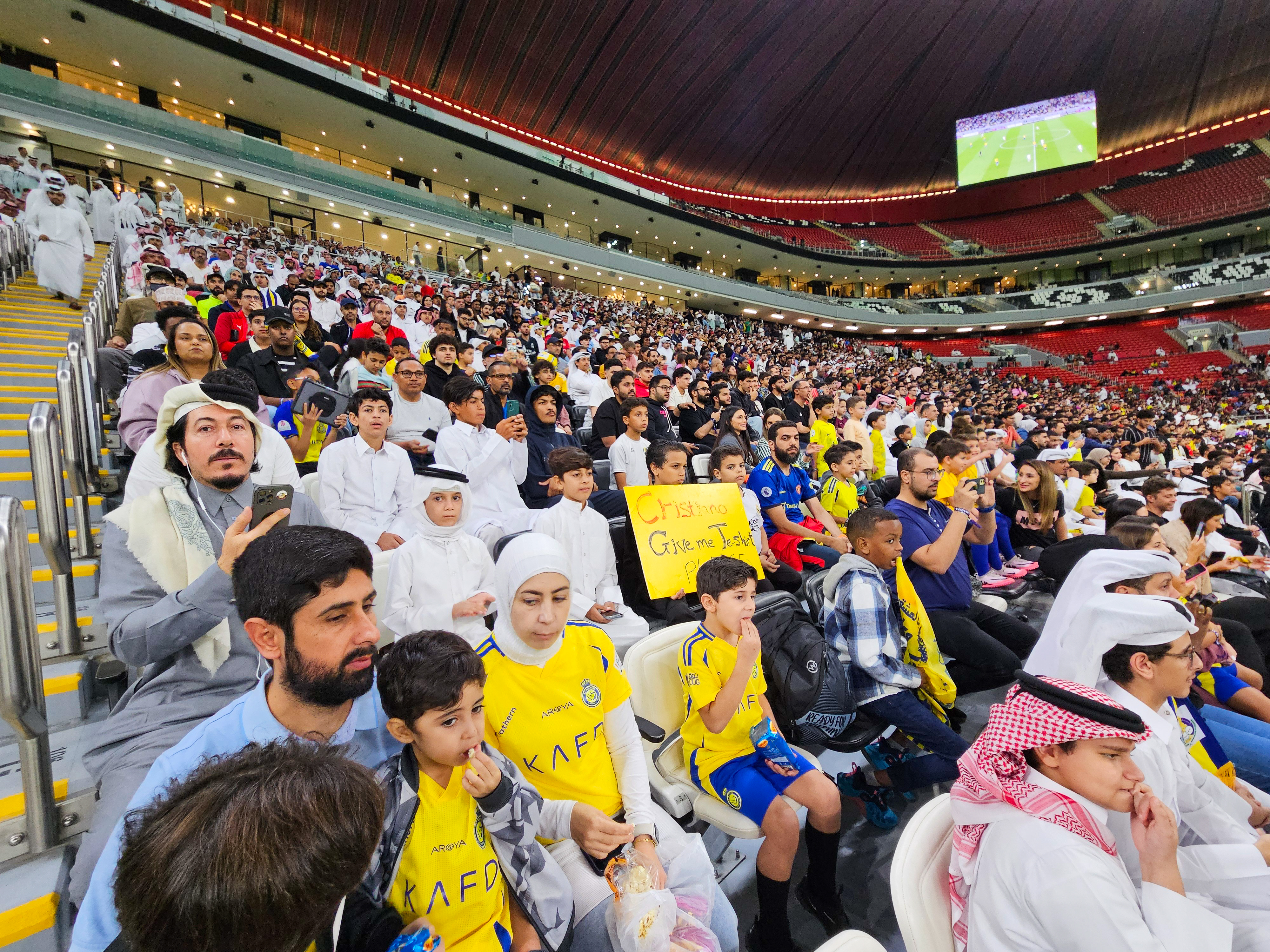 Football fans at the AFC Champions League Elite Group B match between Al Gharafa SC of Qatar and Al Nassr FC at the Al Bayt Stadium in Al Khor, Qatar [Hafsa Adil/Al Jazeera]