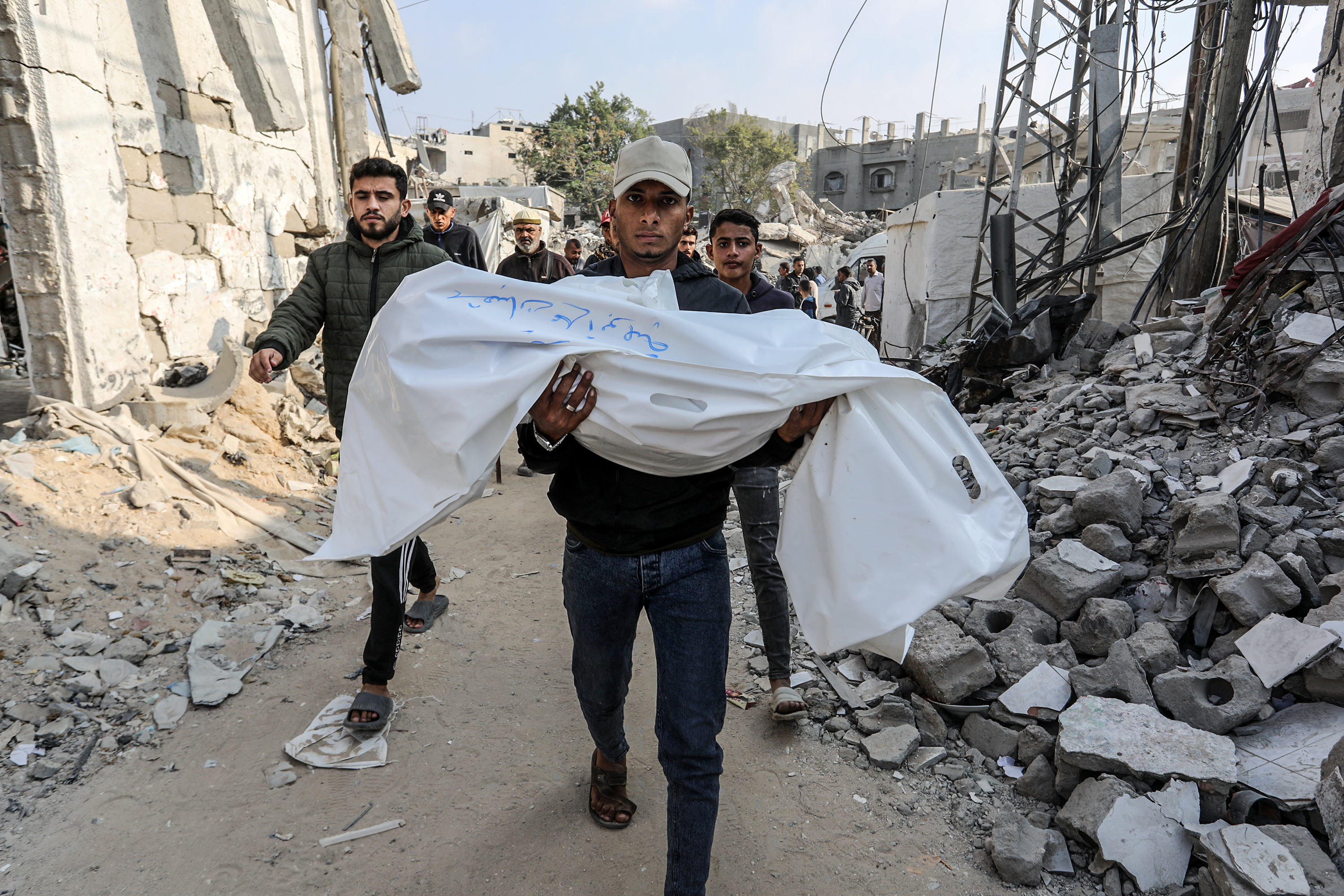 Relatives of Palestinians killed in Israeli attacks on the Abu Lahya family’s house mourn as their bodies are brought to the European Hospital for burial in Khan Younis