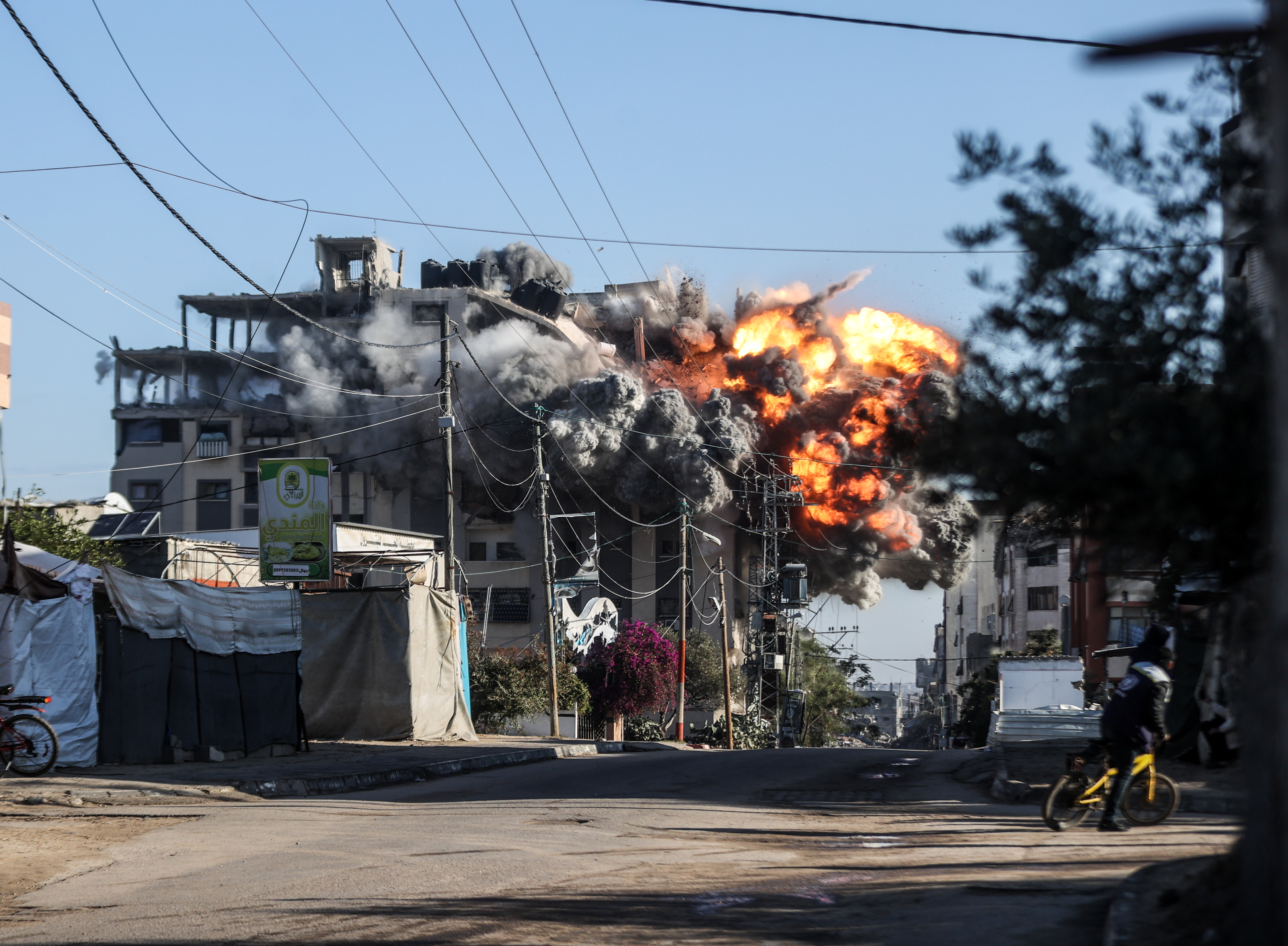 Smoke and dust rise from a residential building after an Israeli attack in the Nuseirat refugee camp in central Gaza