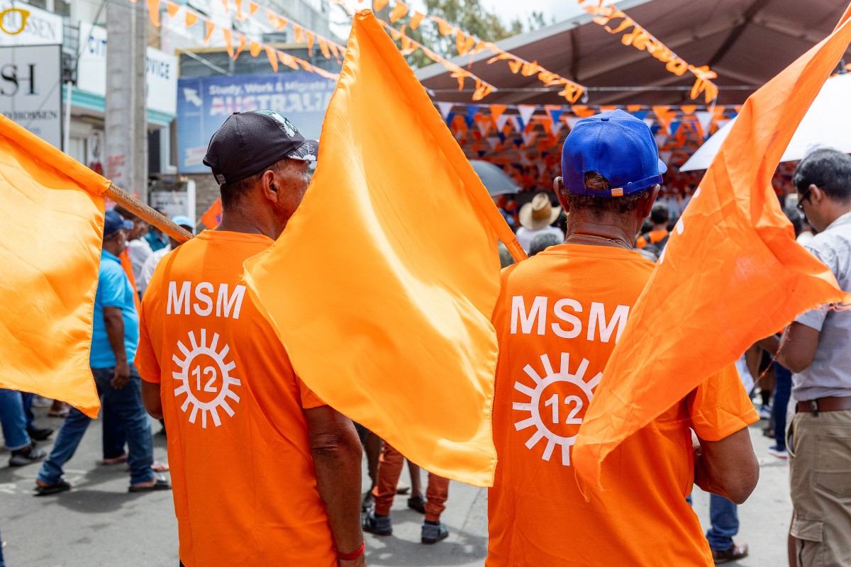 Supporters of the Militant Socialist Movement (MSM) party hold flags while attending a campaign rally led by Prime Minister of Mauritius and candidate Pravind Jugnauth in Mahebourg on October 20, 2024, ahead of the general election. [Laura Morosoli/AFP]