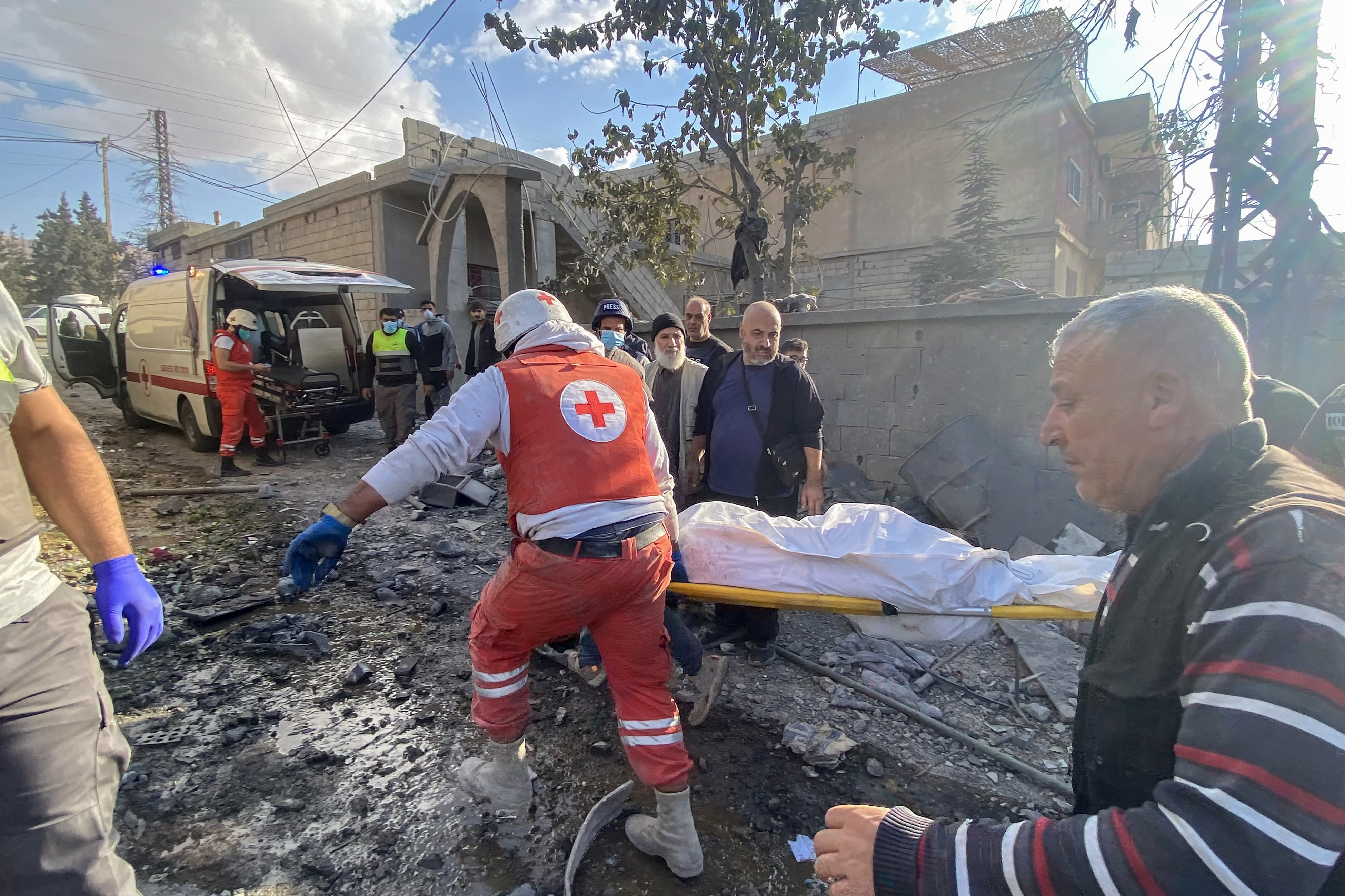 Rescuers carry a body at the site of an Israeli attack in the eastern village of Bazzaliyeh in Bekaa Valley's Hermel district, Lebanon, November 1, 2024