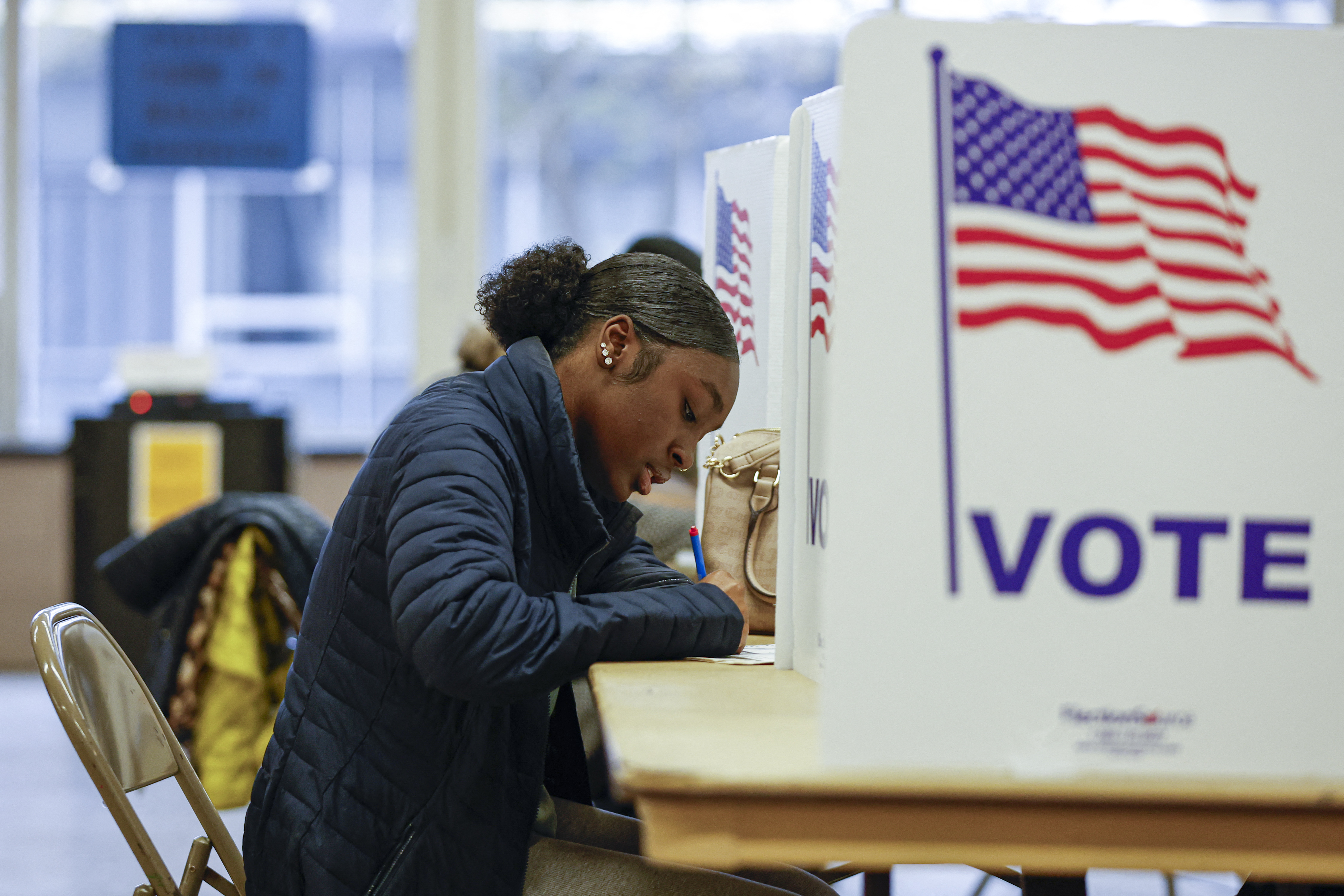 A woman casts her ballot during early voting for the US general election