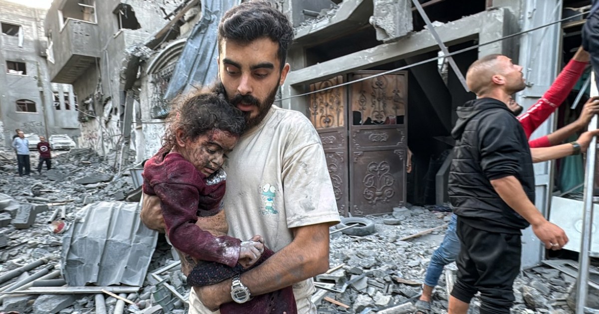 A Palestinian man carries an injured child that was rescued from a home hit in an Israeli strike on the Jabalia refugee camp in the northern Gaza Strip, on November 7, 2024 [AFP]
