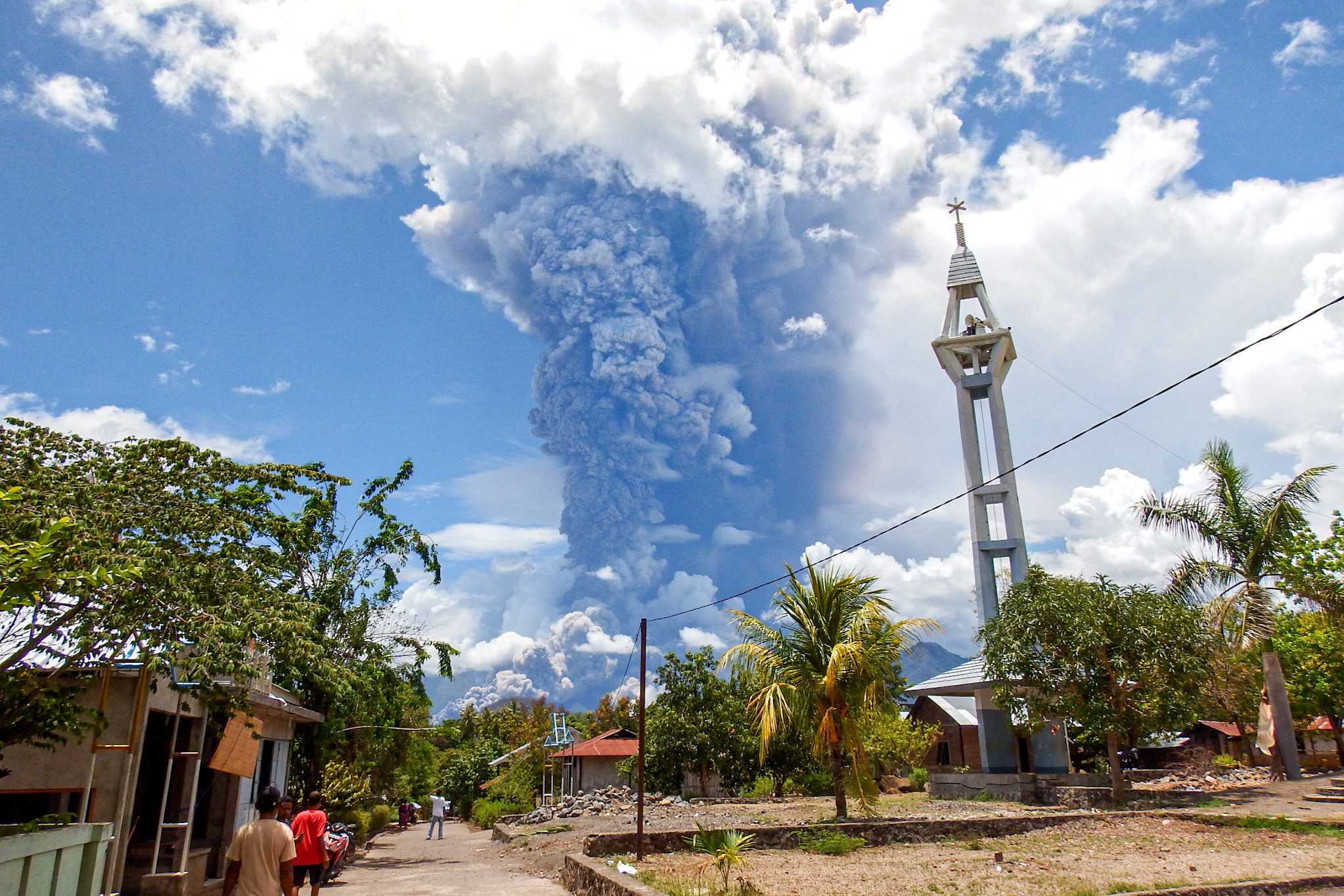 Schoolchildren run during the eruption of Mount Lewotobi Laki-Laki