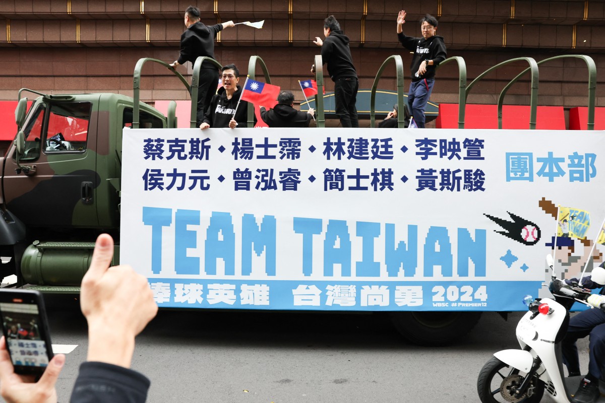 People cheer on players of Team Taiwan during a parade held to celebrate winning the WBSC Premier12 2024 baseball tournament, in Taipei
