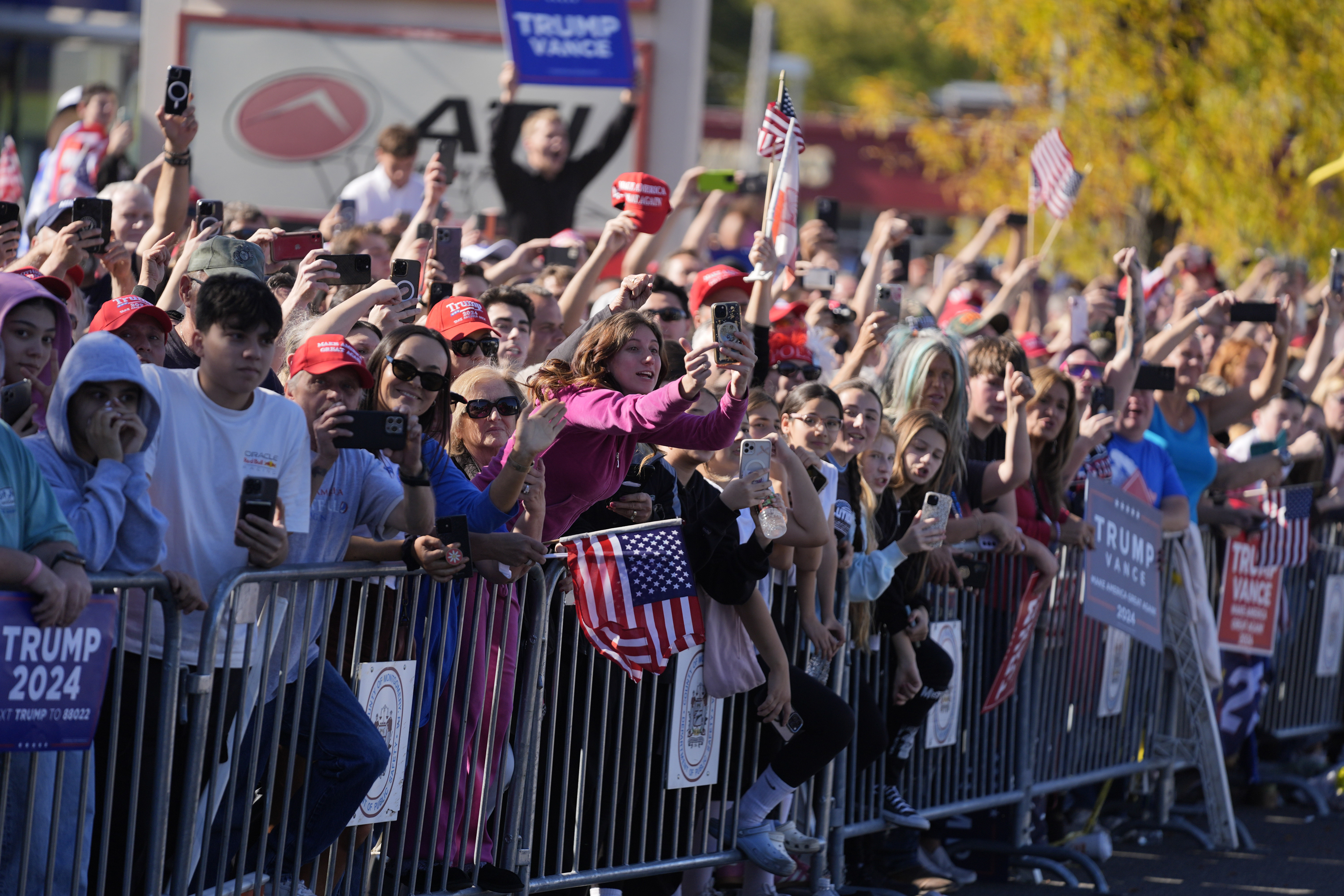 Crowds of supporters gather along the roadside near a McDonald's to cheer Donald Trump's photo op at the restaurant.