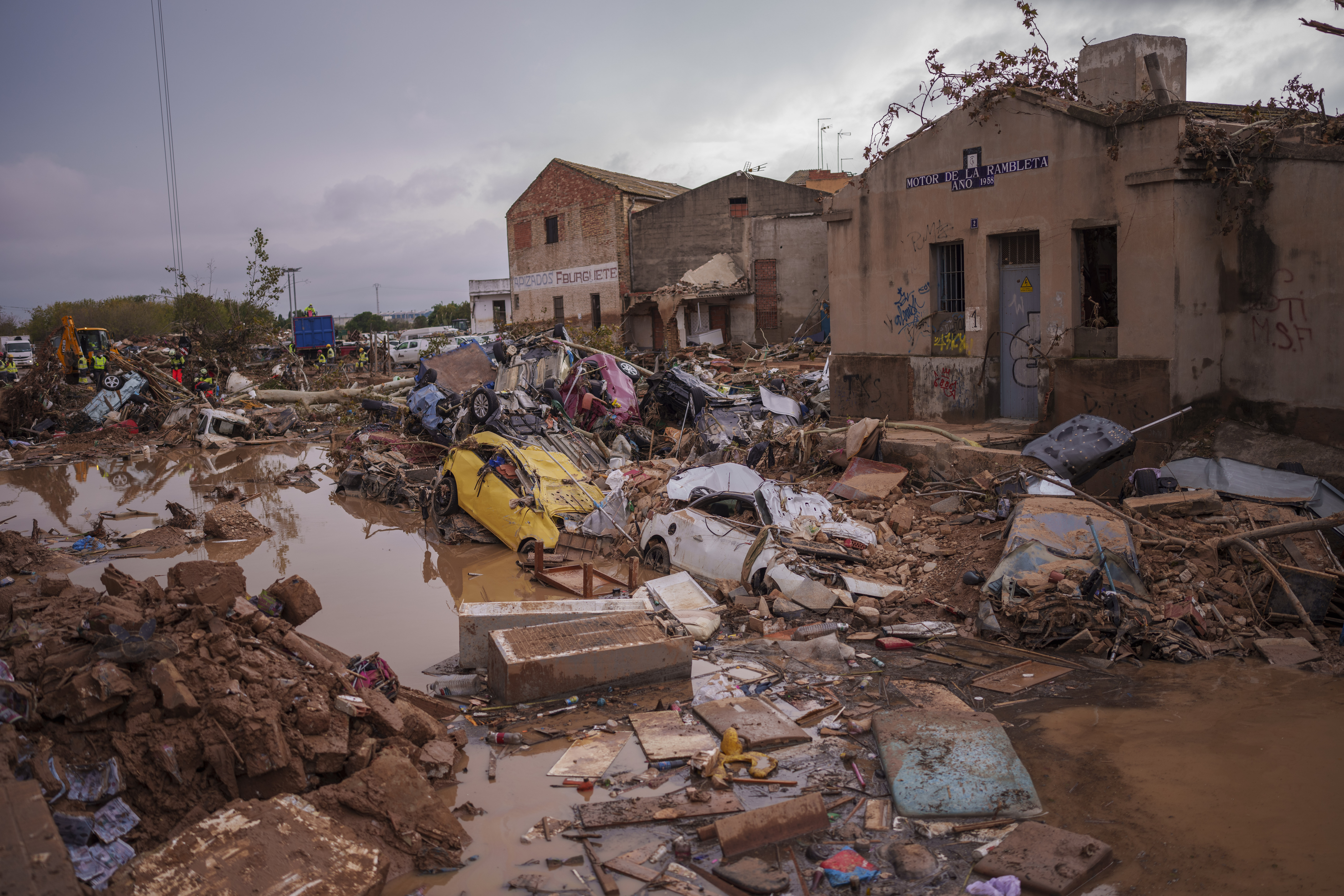 Heavy rains in Barcelona disrupt rail service as troops search for more flood victims in Valencia