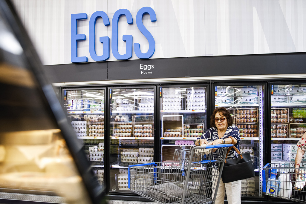 A woman shops for eggs in a store