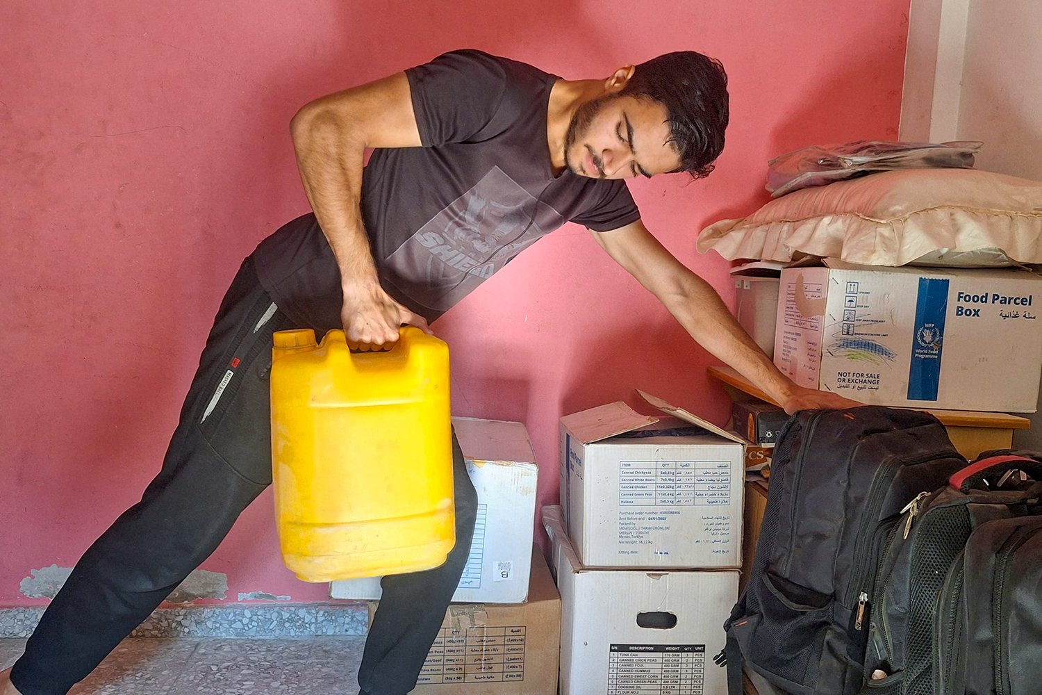 Mohamed Hatem working out at home with a water cannister.