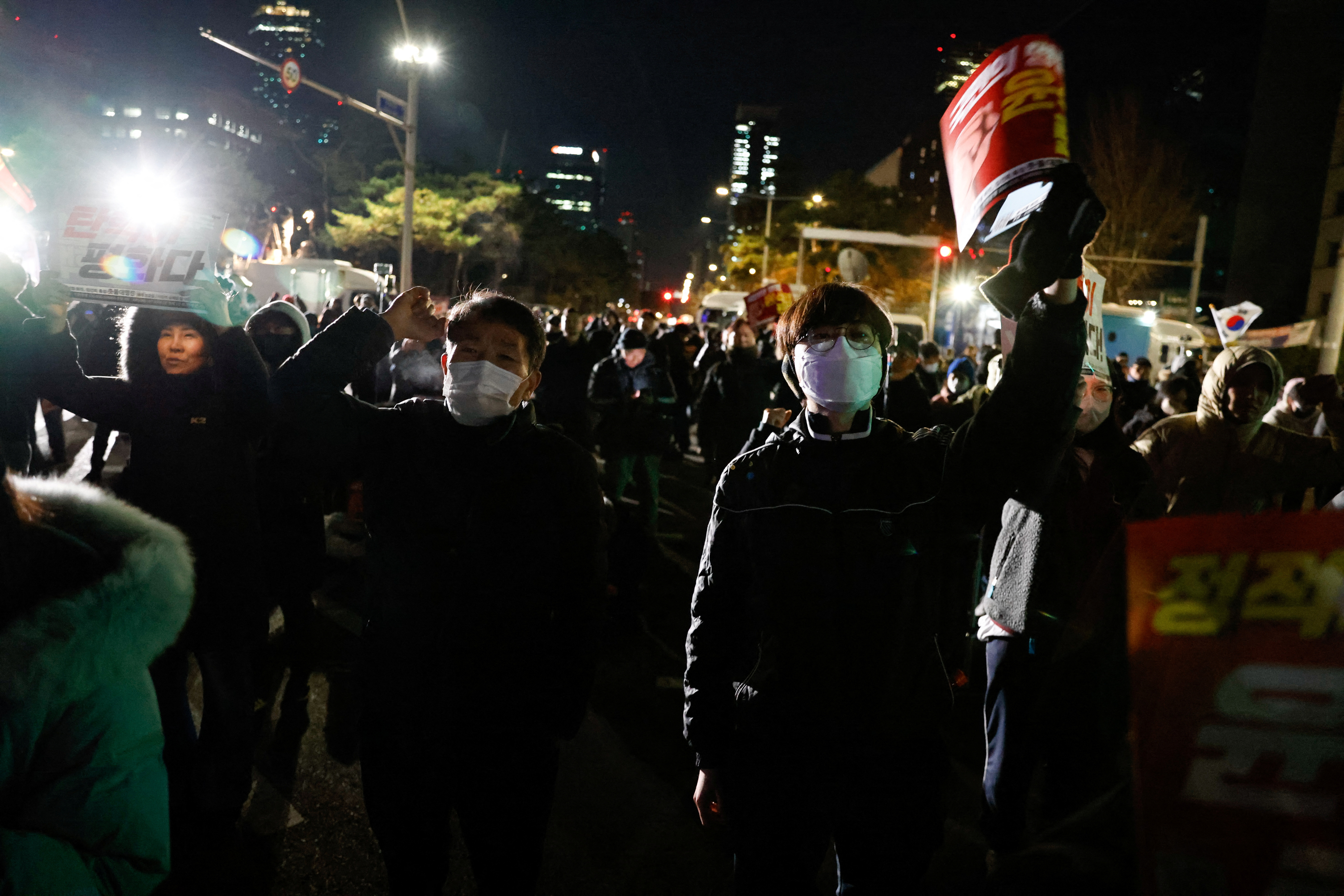 People react outside National Assembly, after South Korean President Yoon Suk Yeol announced that he will lift the martial law