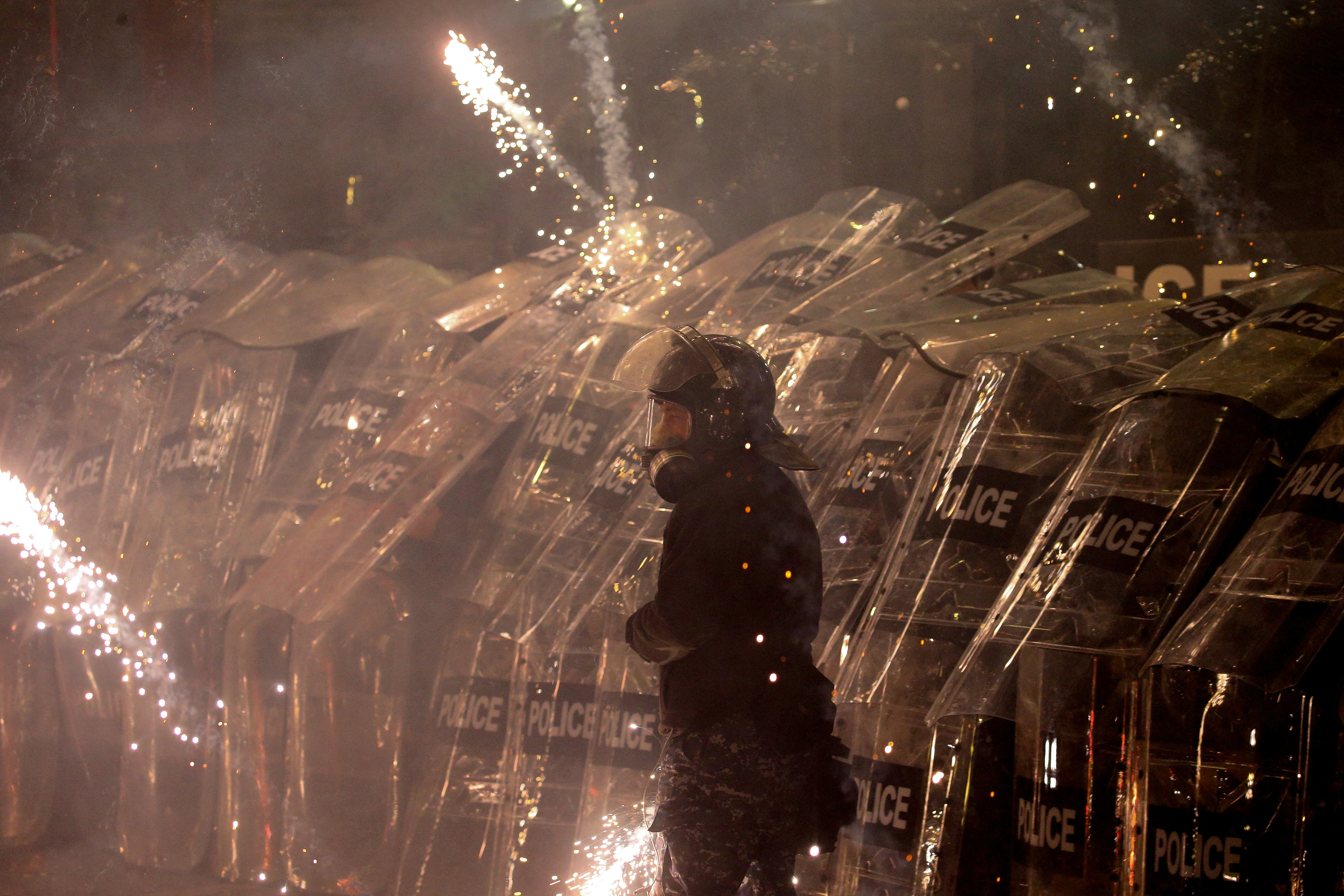 Police officers use shields as supporters of Georgia's opposition parties hold a rally to protest against the government's decision to suspend talks on joining the European Union, in Tbilisi