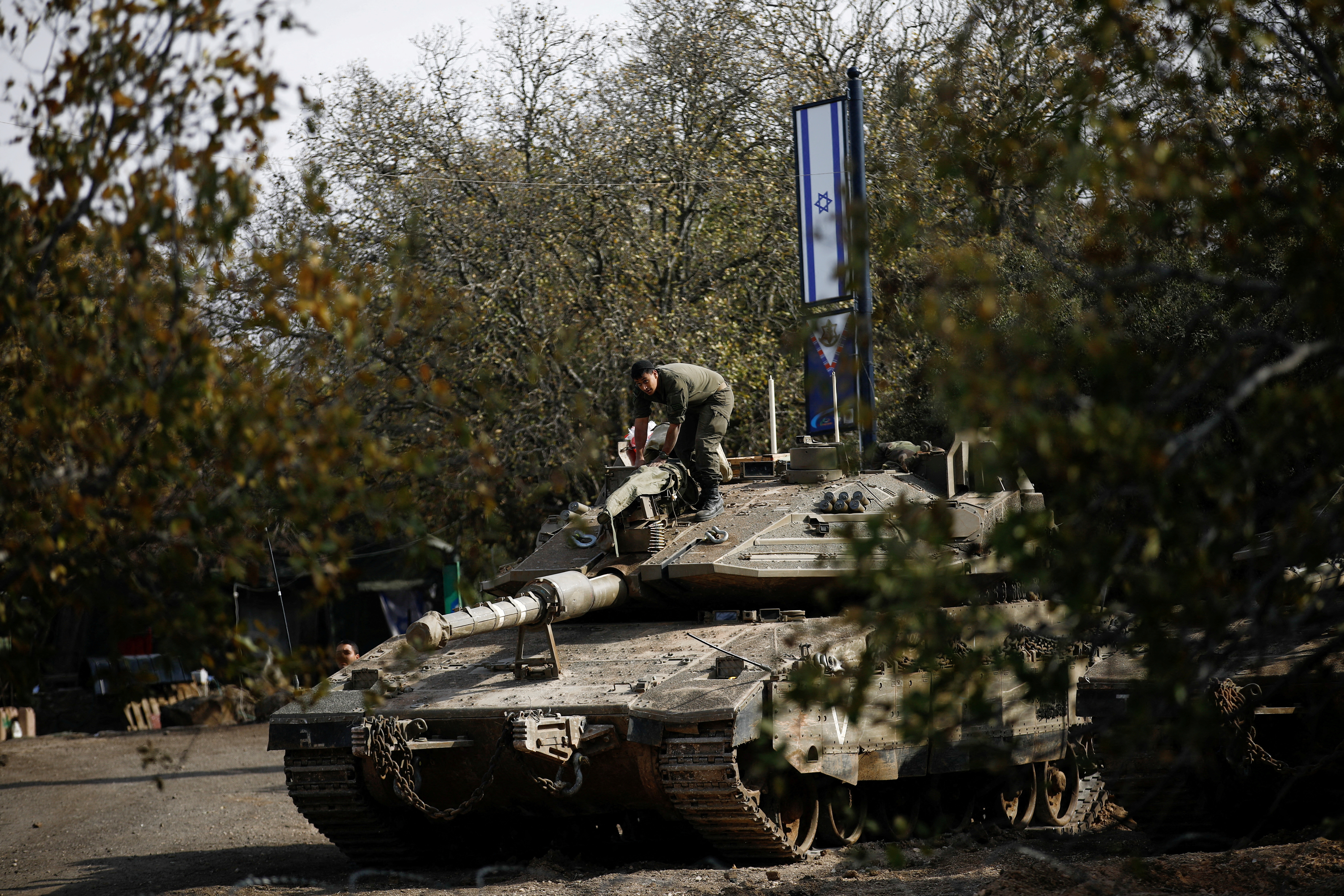 An Israeli soldier stands on a tank, near the ceasefire line between Syria and the Israeli-occupied Golan Heights
