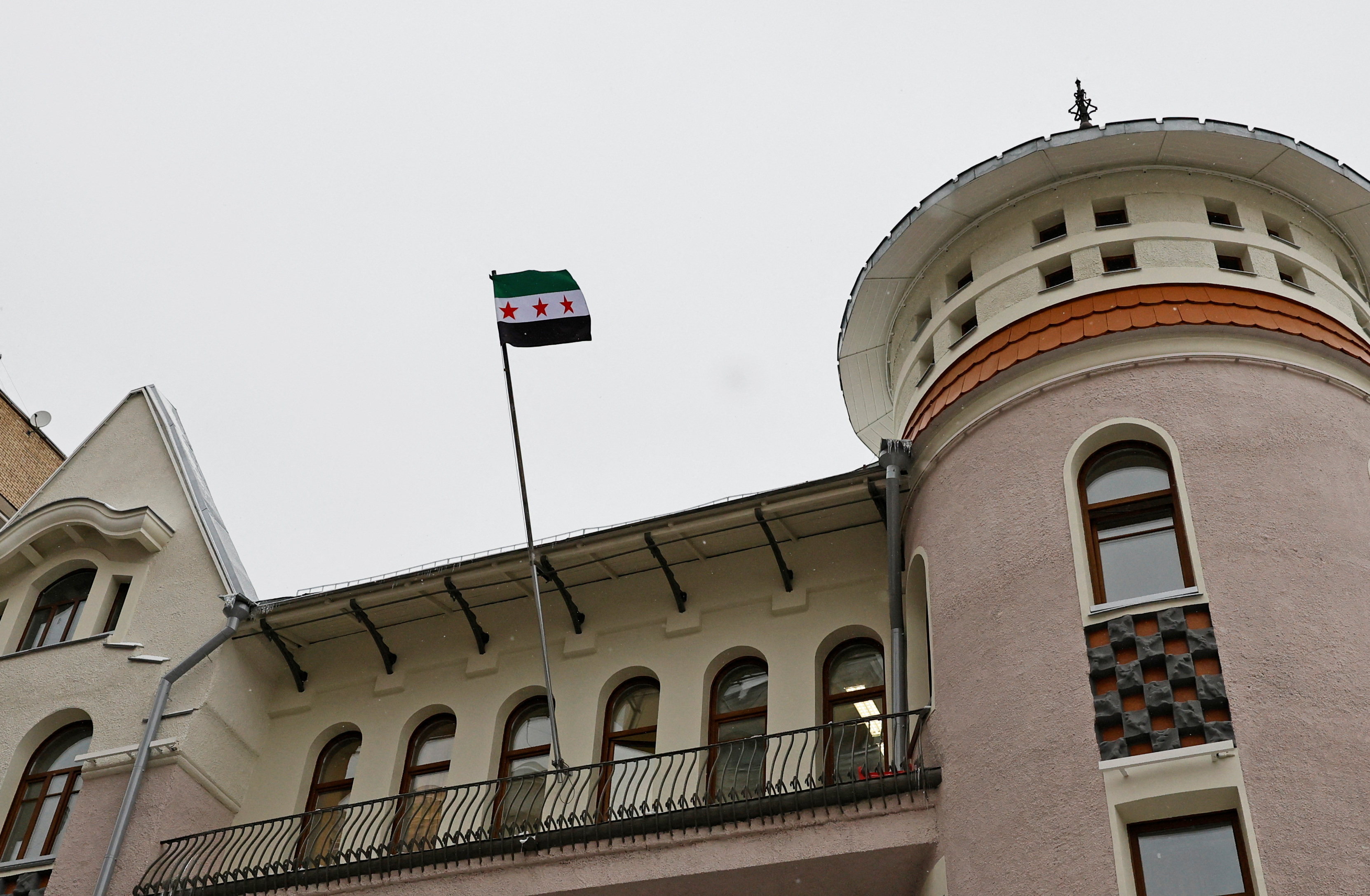 Images with the Syrian opposition flag raised at the embassy in Moscow