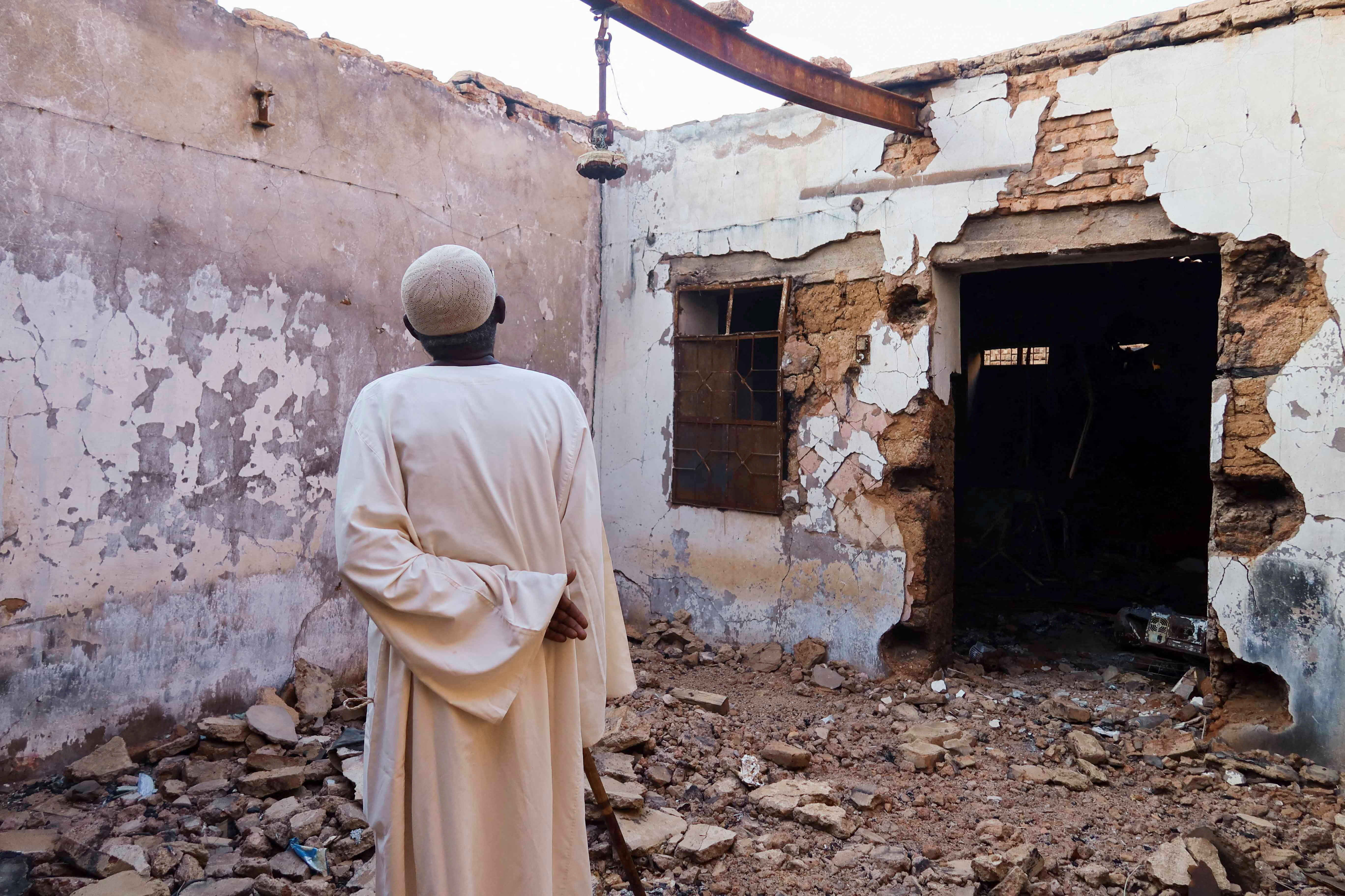 A resident of the Old-Omdurman neighbourhood looks at his house after it was damaged by shells.
