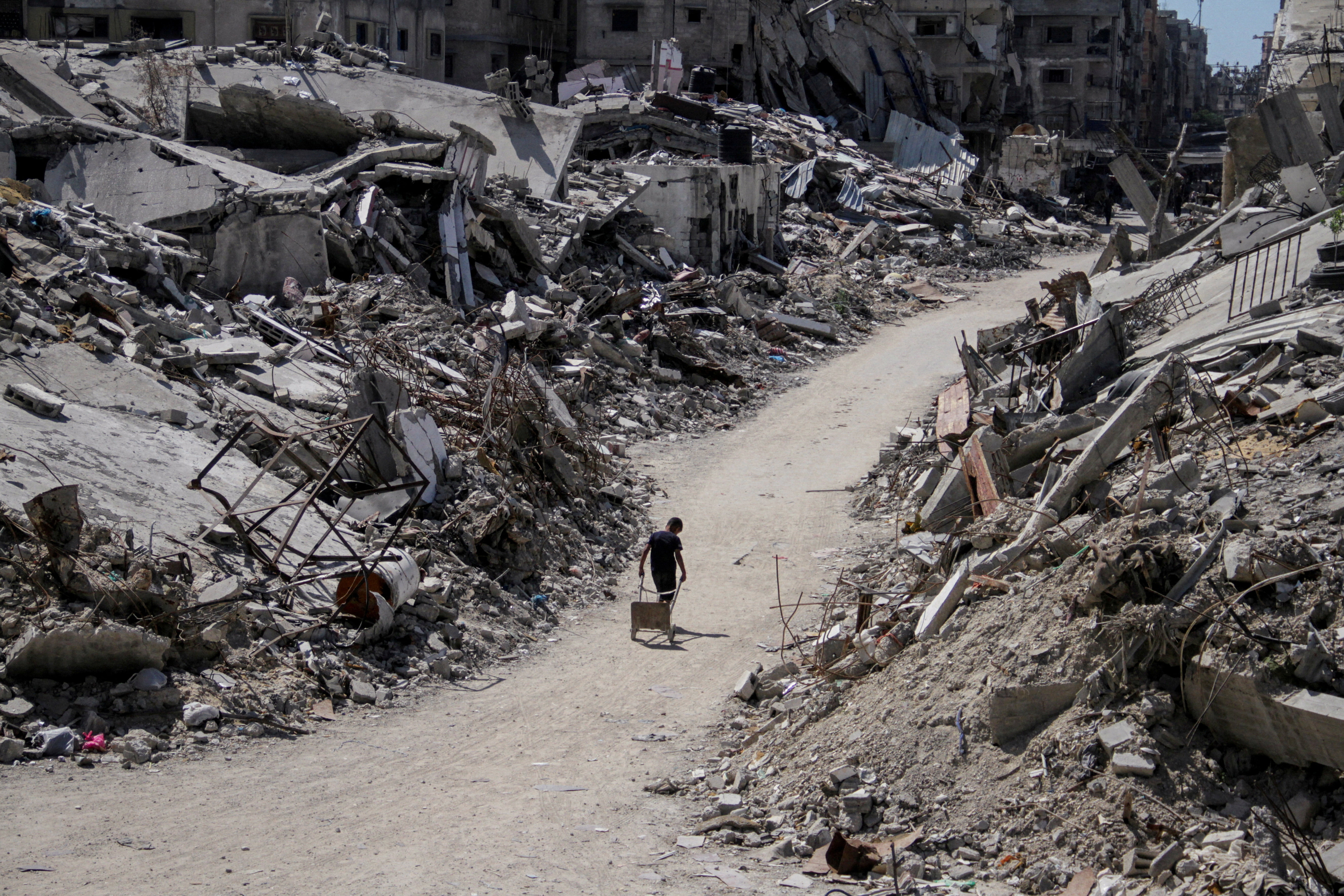 A Palestinian walks among the rubble of damaged buildings, which were destroyed during Israel's military offensive, amid the ongoing conflict between Israel and Hamas, in Beit Lahia in the northern Gaza Strip, June 12, 2024. REUTERS/Mahmoud Issa TPX IMAGES OF THE DAY SEARCH "REUTERS MIDDLE EAST 2024" FOR THIS STORY. SEARCH "REUTERS YEAR-END" FOR ALL 2024 YEAR END GALLERIES.