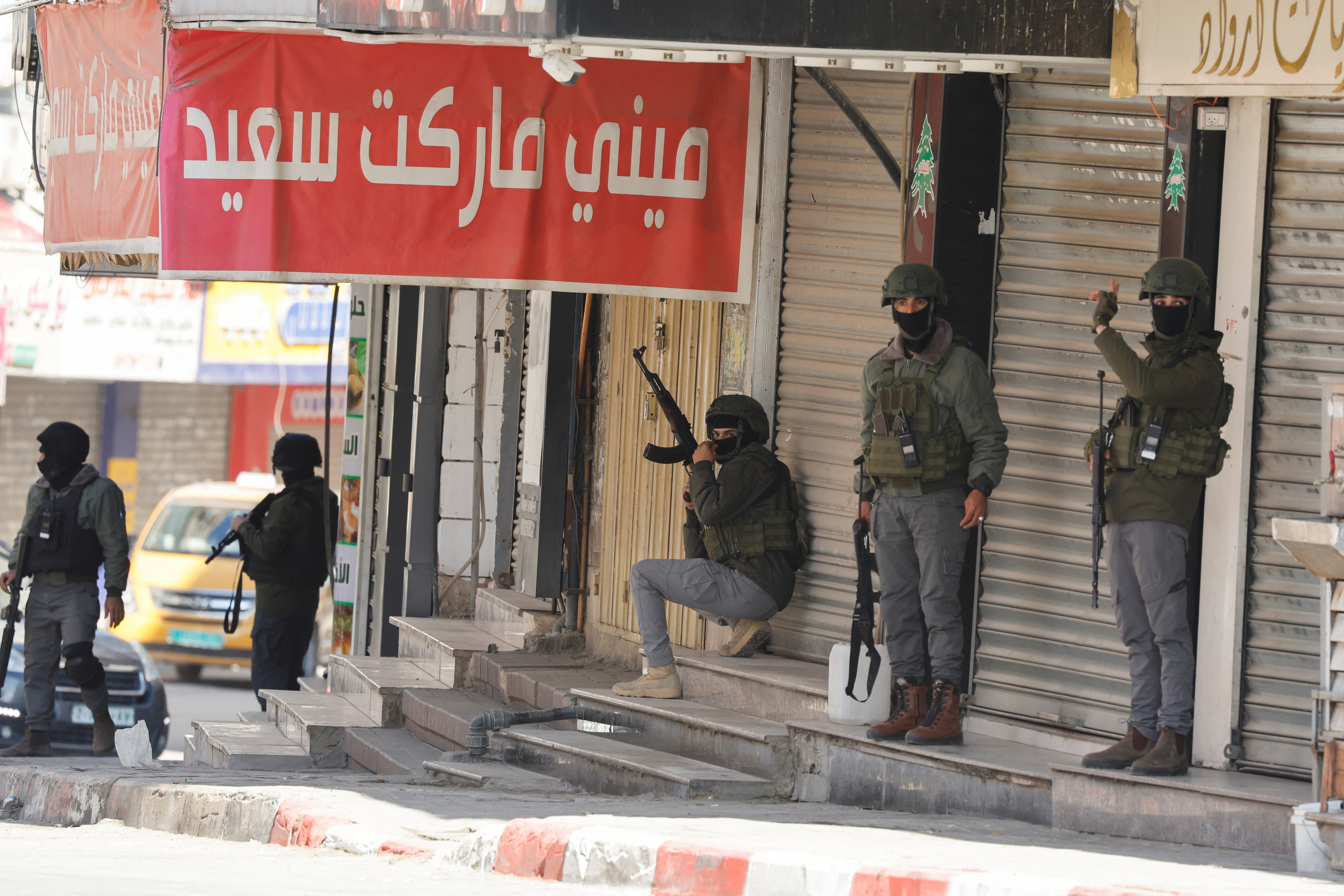 Palestinian security forces take position during clashes with militants at the camp, in Jenin in the Israeli-occupied West Bank, December 14, 2024. REUTERS/Raneen Sawafta