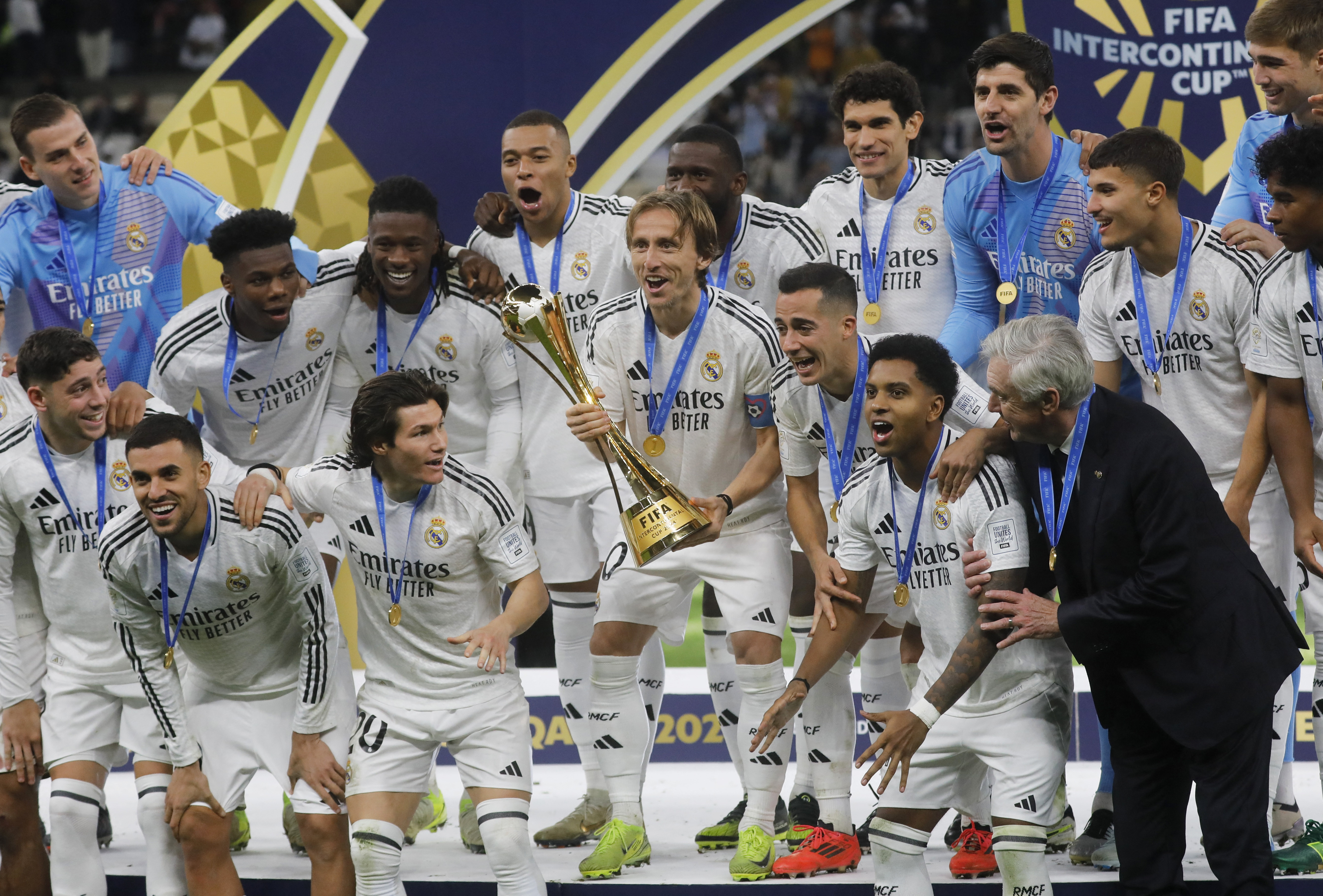 Soccer Football - Intercontinental Cup - Final - Real Madrid v Pachuca - Lusail Stadium, Lusail, Qatar - December 18, 2024 Real Madrid's Luka Modric lifts the trophy as he celebrates with teammates after winning the Intercontinental Cup REUTERS/Ibraheem Abu Mustafa