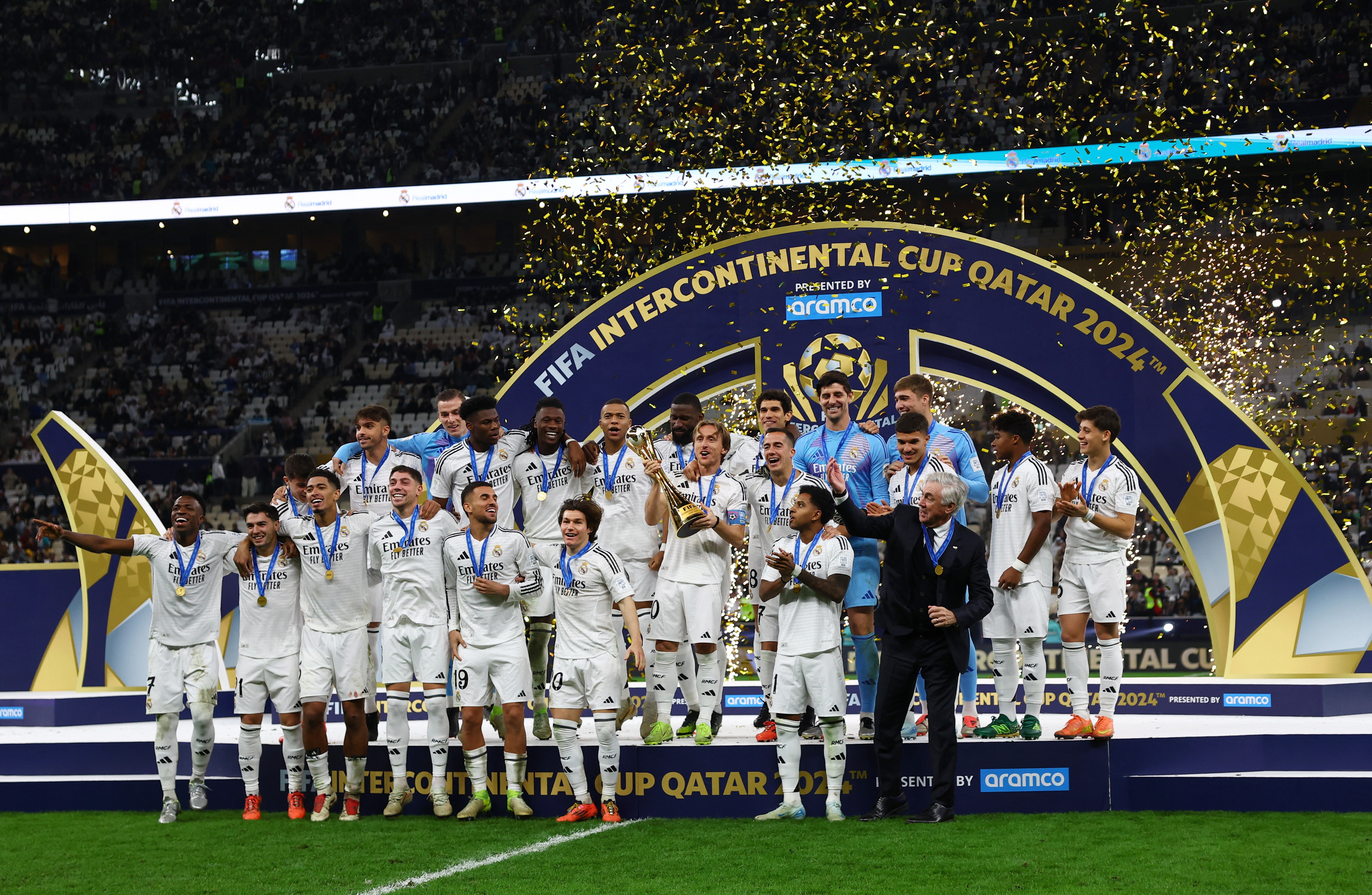 Soccer Football - Intercontinental Cup - Final - Real Madrid v Pachuca - Lusail Stadium, Lusail, Qatar - December 18, 2024 Real Madrid's Luka Modric lifts the trophy as he celebrates with teammates after winning the Intercontinental Cup REUTERS/Rula Rouhana