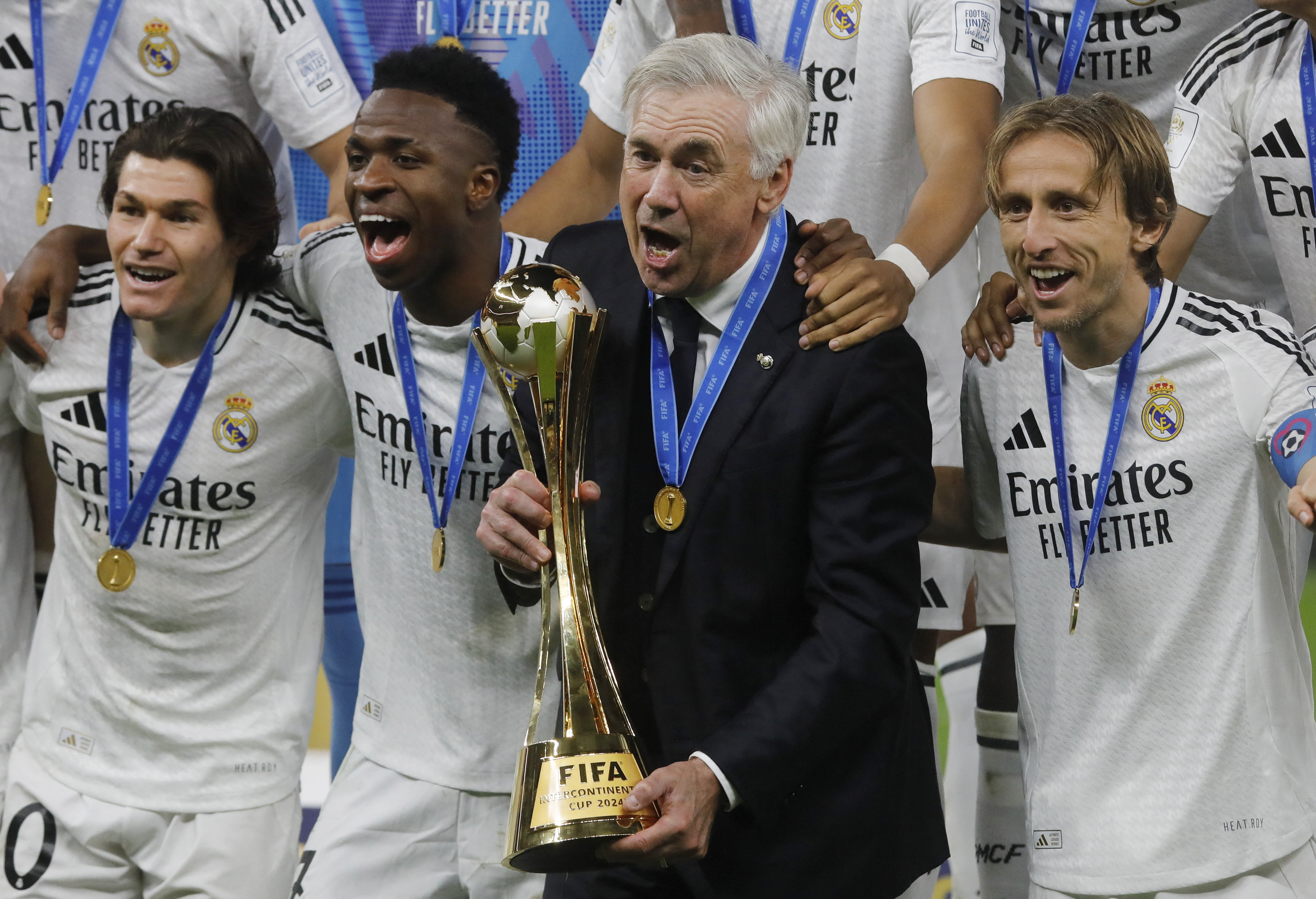 Soccer Football - Intercontinental Cup - Final - Real Madrid v Pachuca - Lusail Stadium, Lusail, Qatar - December 18, 2024 Real Madrid coach Carlo Ancelotti, Fran Garcia, Vinicius Junior and Luka Modric celebrate with the trophy after winning the Intercontinental Cup REUTERS/Ibraheem Abu Mustafa