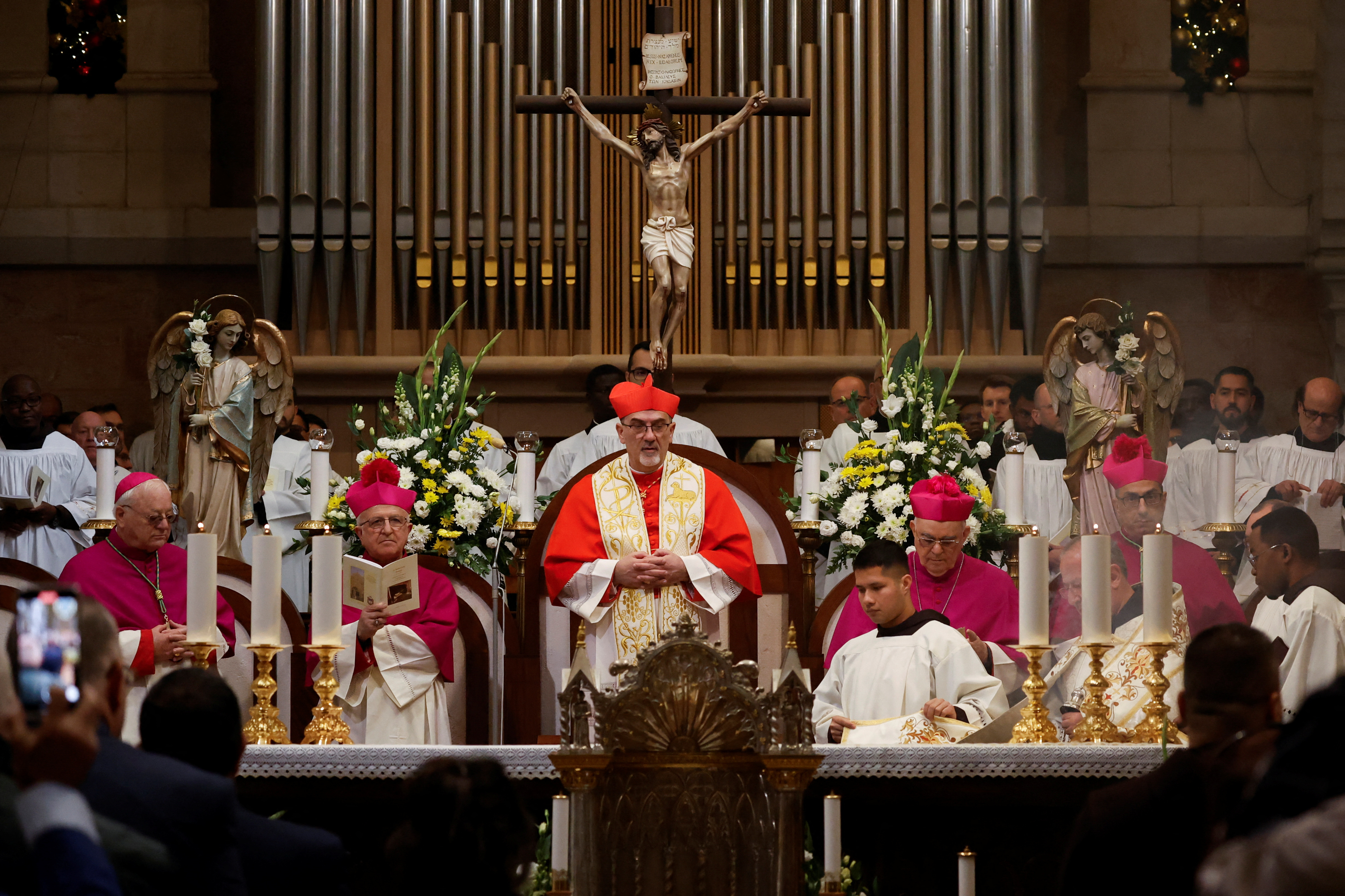 The Latin Patriarch of Jerusalem, Pierbattista Pizzaballa, leads a mass at the Church of Nativity in the Old City of Bethlehem, in the Israeli-occupied West Bank
