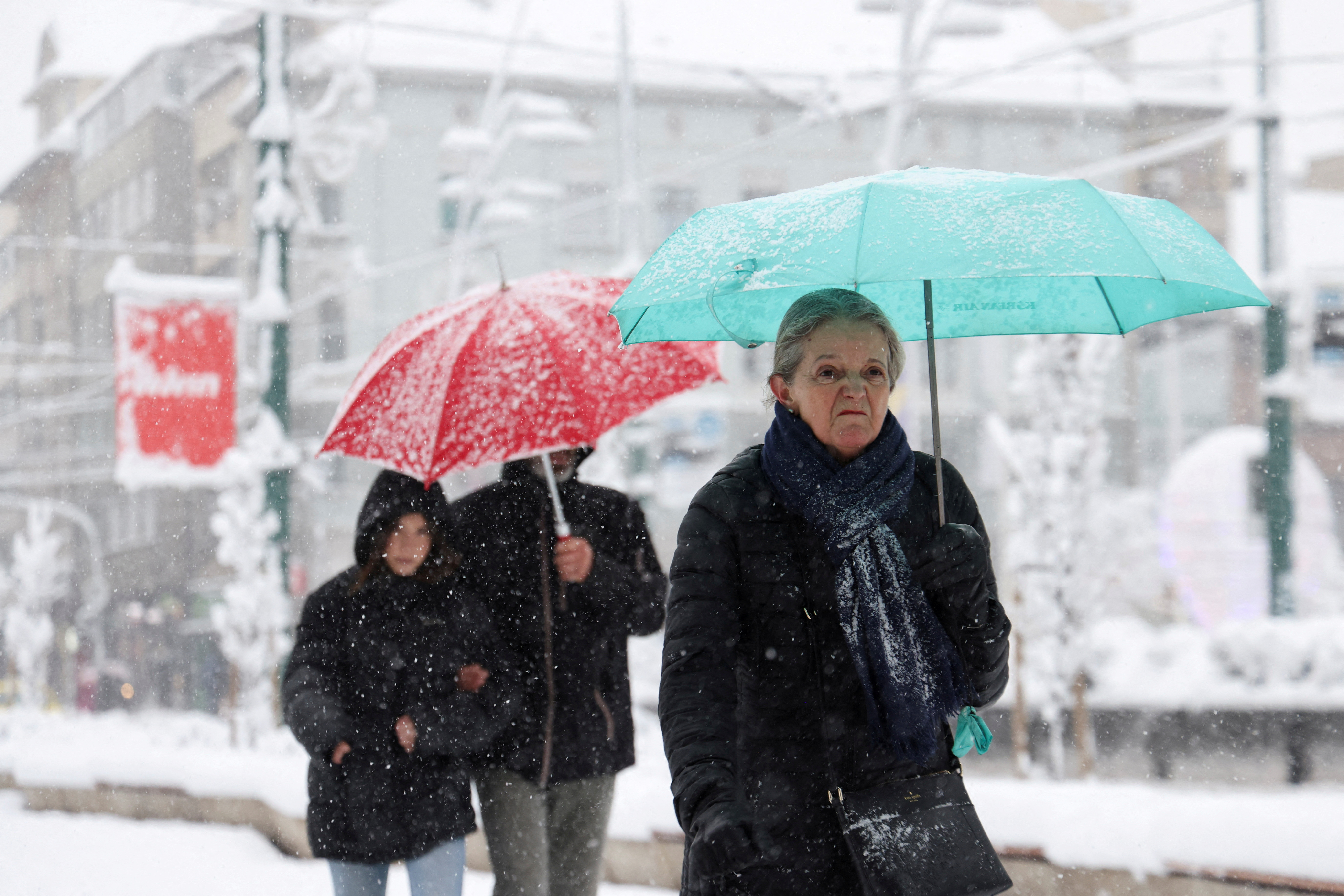 People walk on the street during a snowstorm, in Sarajevo, Bosnia and Herzegovina, December 24, 2024. REUTERS/Amel Emric TPX IMAGES OF THE DAY