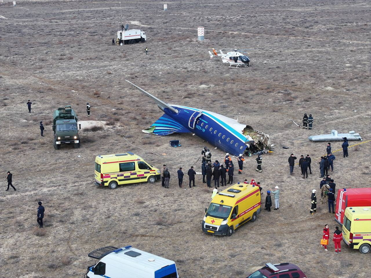A drone view shows emergency specialists working at the crash site of an Azerbaijan Airlines passenger plane near the city of Aktau, Kazakhstan