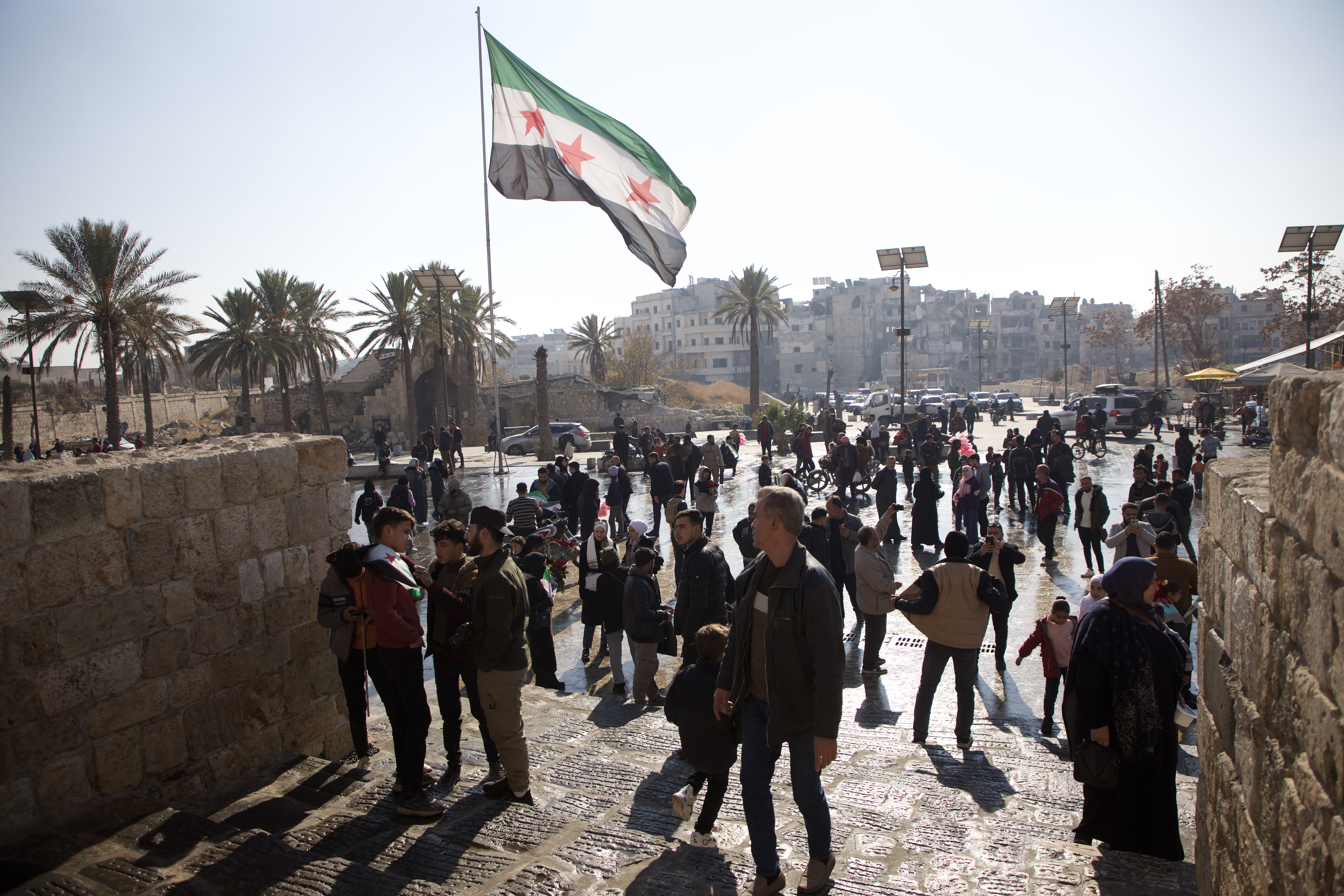 The Syrian flag waves near the historic Aleppo citadel [Ali Haj Suleiman/Al Jazeera]