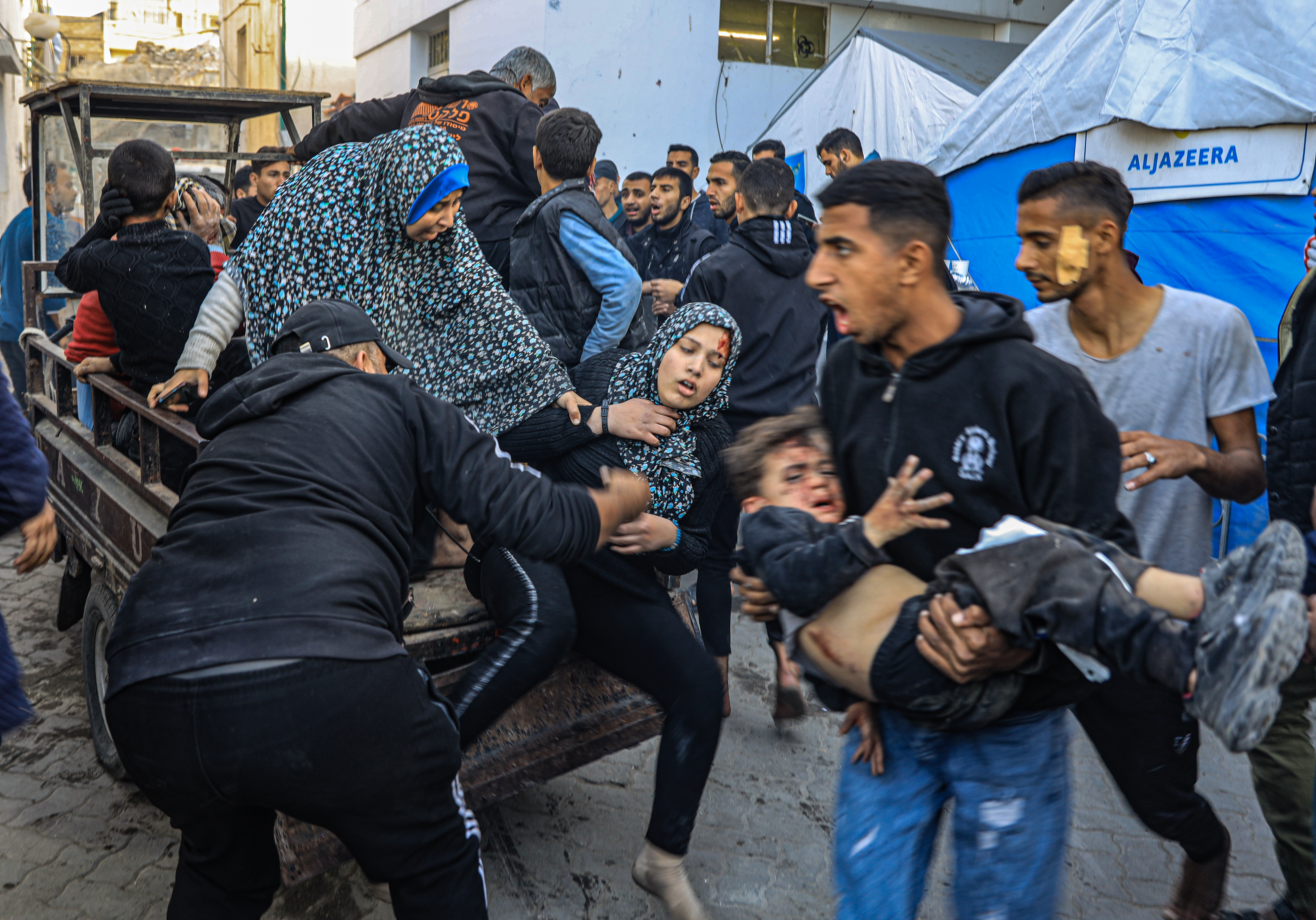 Injured Palestinians are transferred to surrounding hospitals as at least 15 Palestinians were killed and over 30 others injured on Thursday in an Israeli airstrike on Dar al-Arqam and Shaaban al-Rayes schools sheltering displaced people in Gaza City, Gaza on December 19
