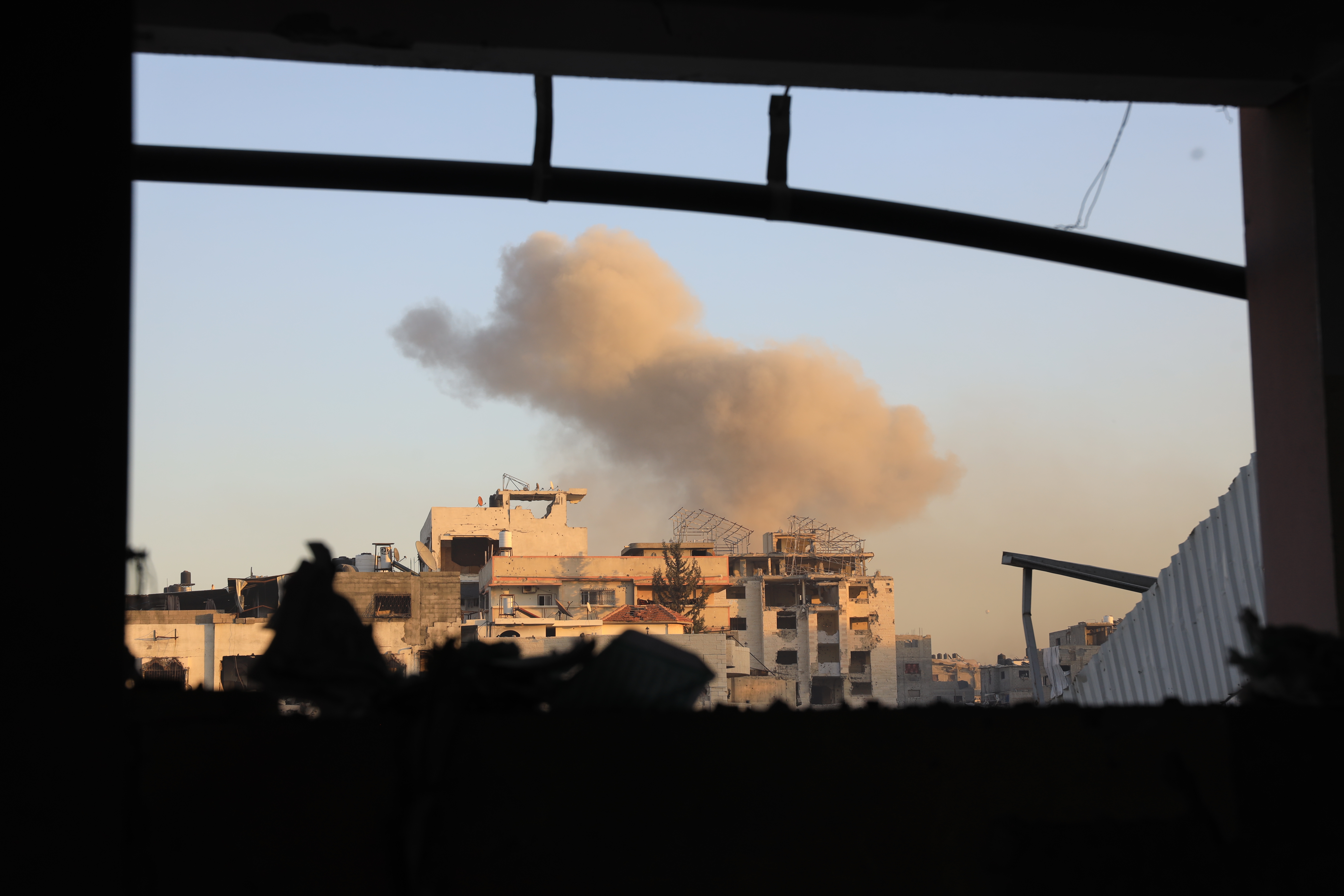 Smoke rises from the residential buildings as at least 15 Palestinians were killed and over 30 others injured on Thursday in an Israeli airstrike on Dar al-Arqam and Shaaban al-Rayes schools sheltering displaced people in Gaza City, Gaza on December 19