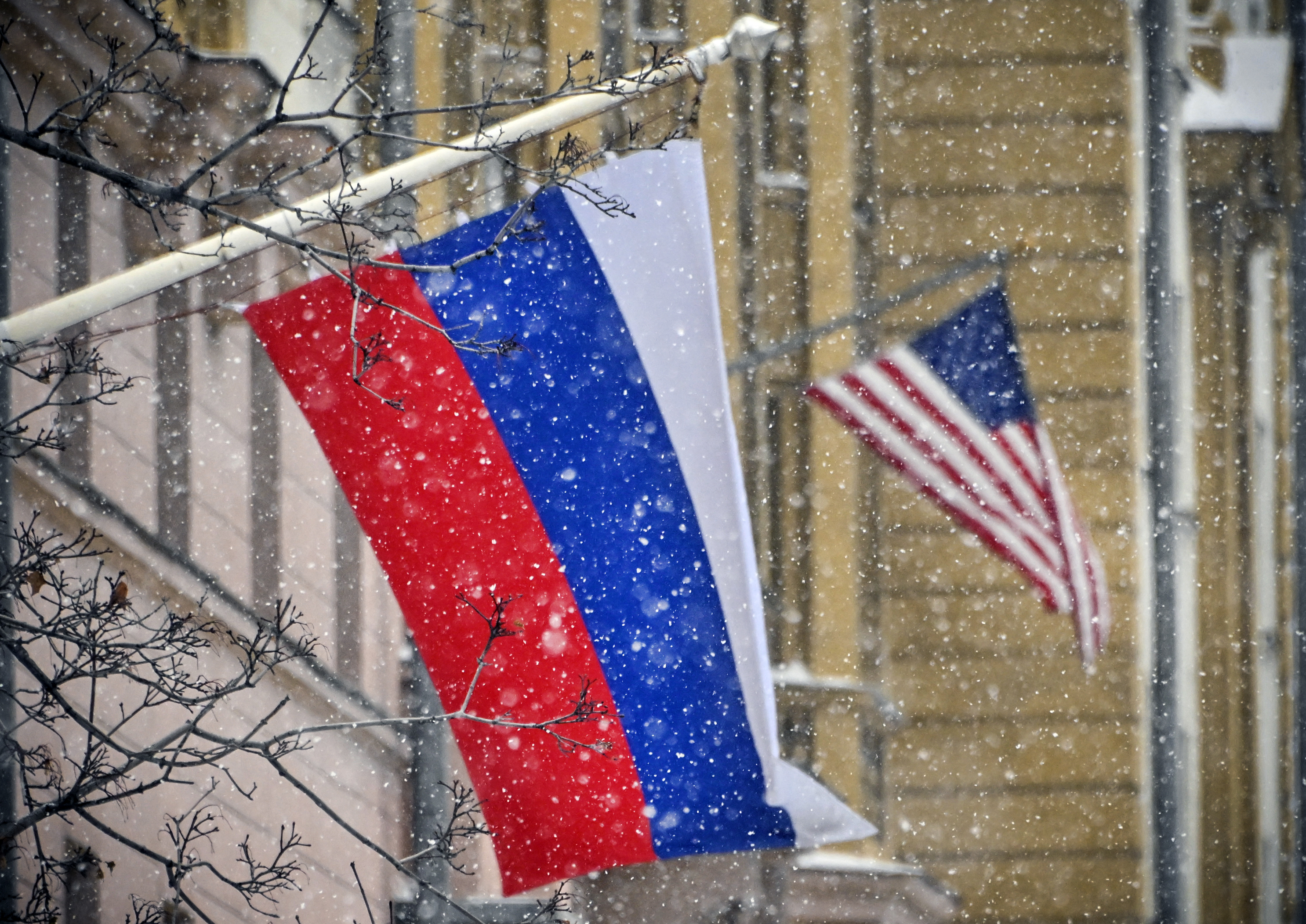A Russian flag flies next to the US Embassy building in Moscow