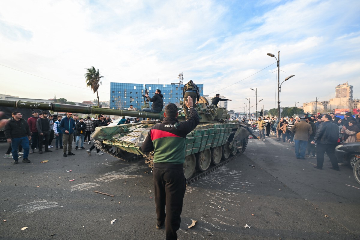 Syria's army command notified officers on Sunday that Assad's regime had ended, a Syrian officer who was informed of the move told Reuters. [Louai Beshara/AFP]