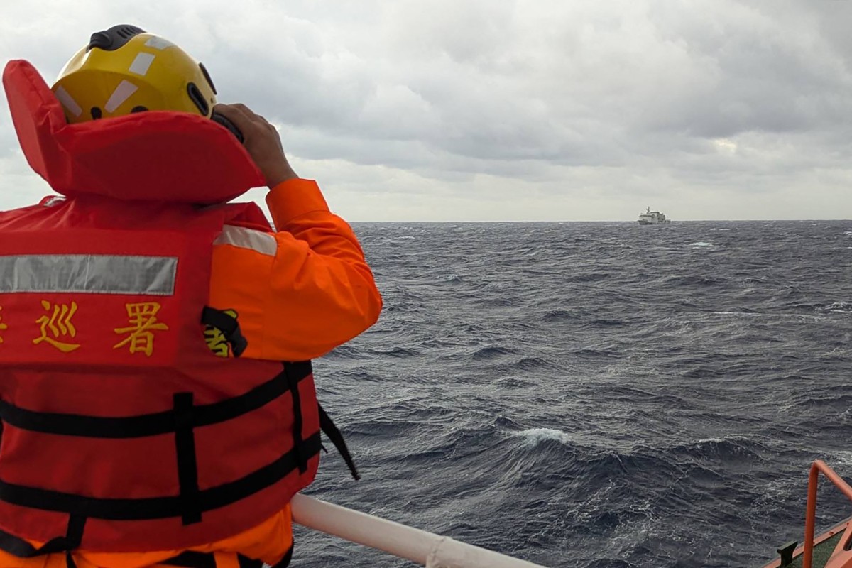 A crewmember on board a Taiwan Coast Guard ship monitoring a Chinese coast guard vessel