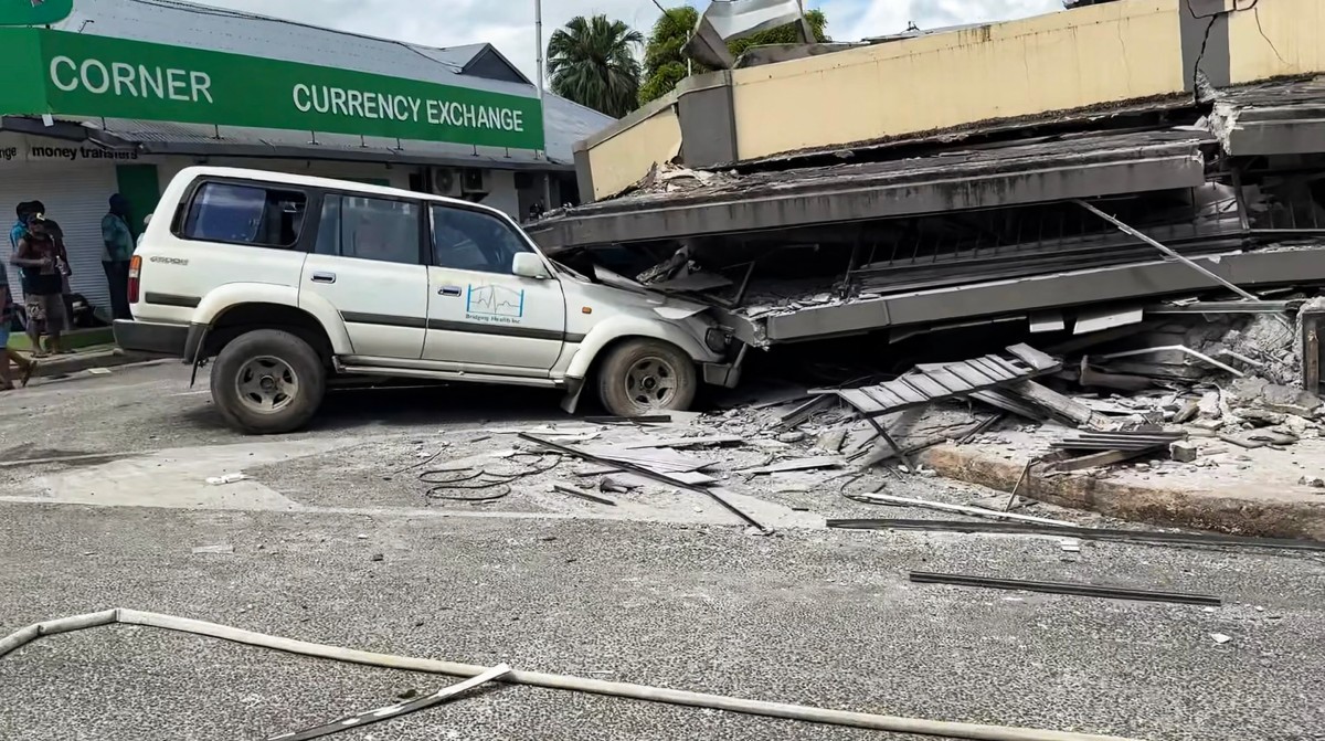 Screengrab taken from video footage posted on the Facebook account of Michael Thompson on December 17, 2024, shows a car trapped underneath a collapsed building in Port Vila
