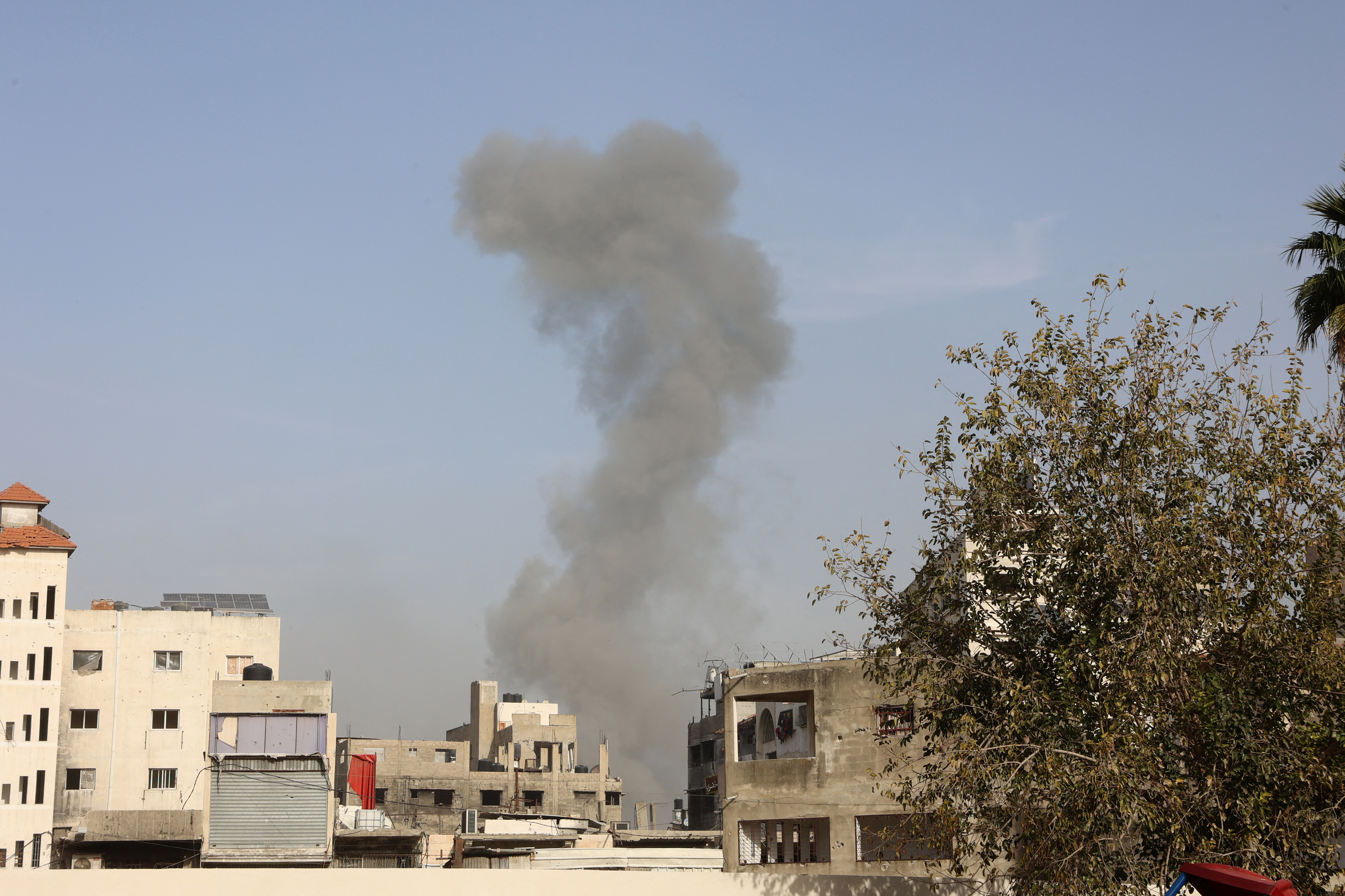 Smoke billows after an Israeli strike at Tuffah neighbourhood east of Gaza City, on December 26