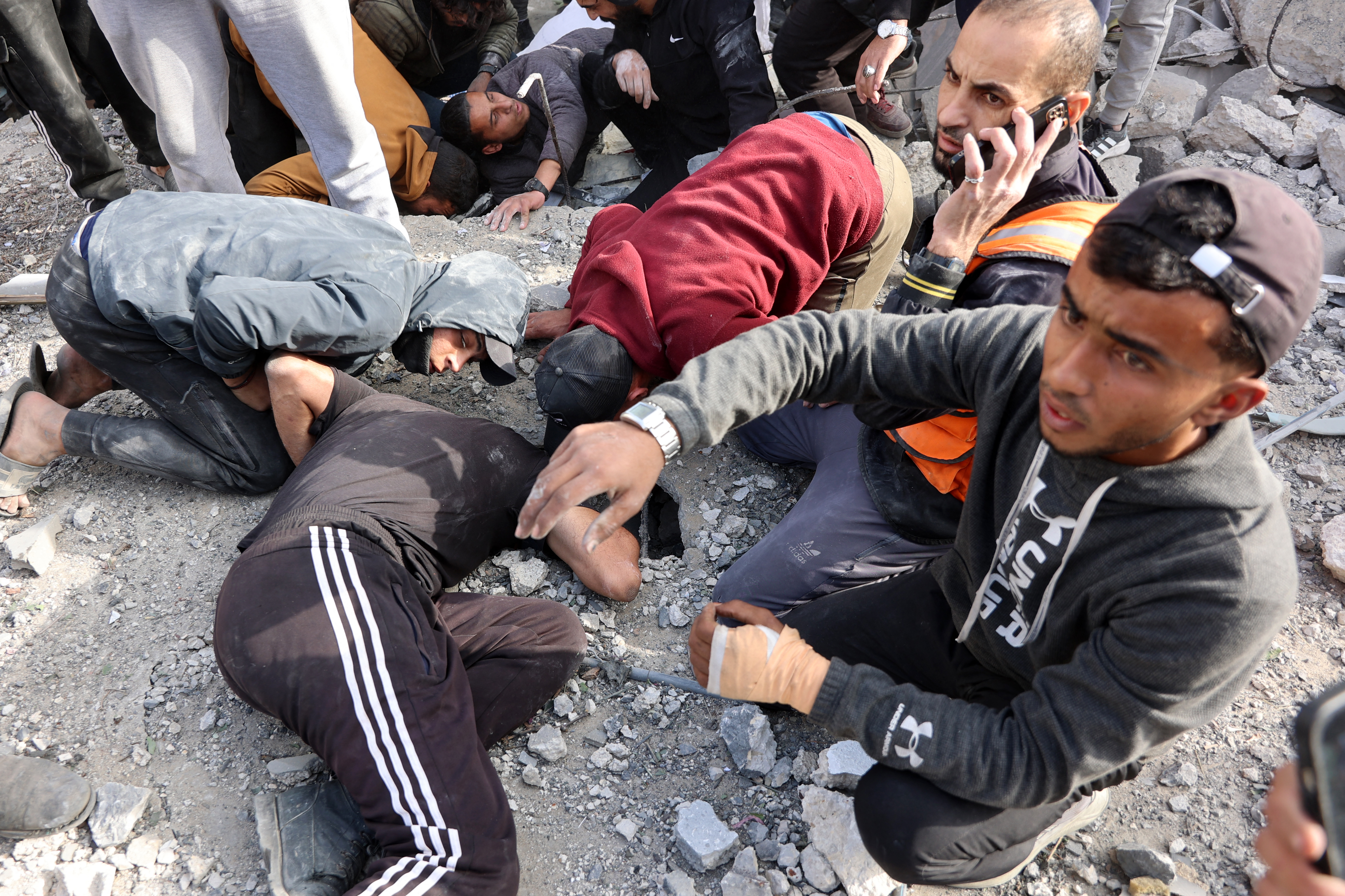 Civilians look for survivors at the site of an Israeli strike in a residential area in the Tuffah neighbourhood, east of Gaza City, on December 26