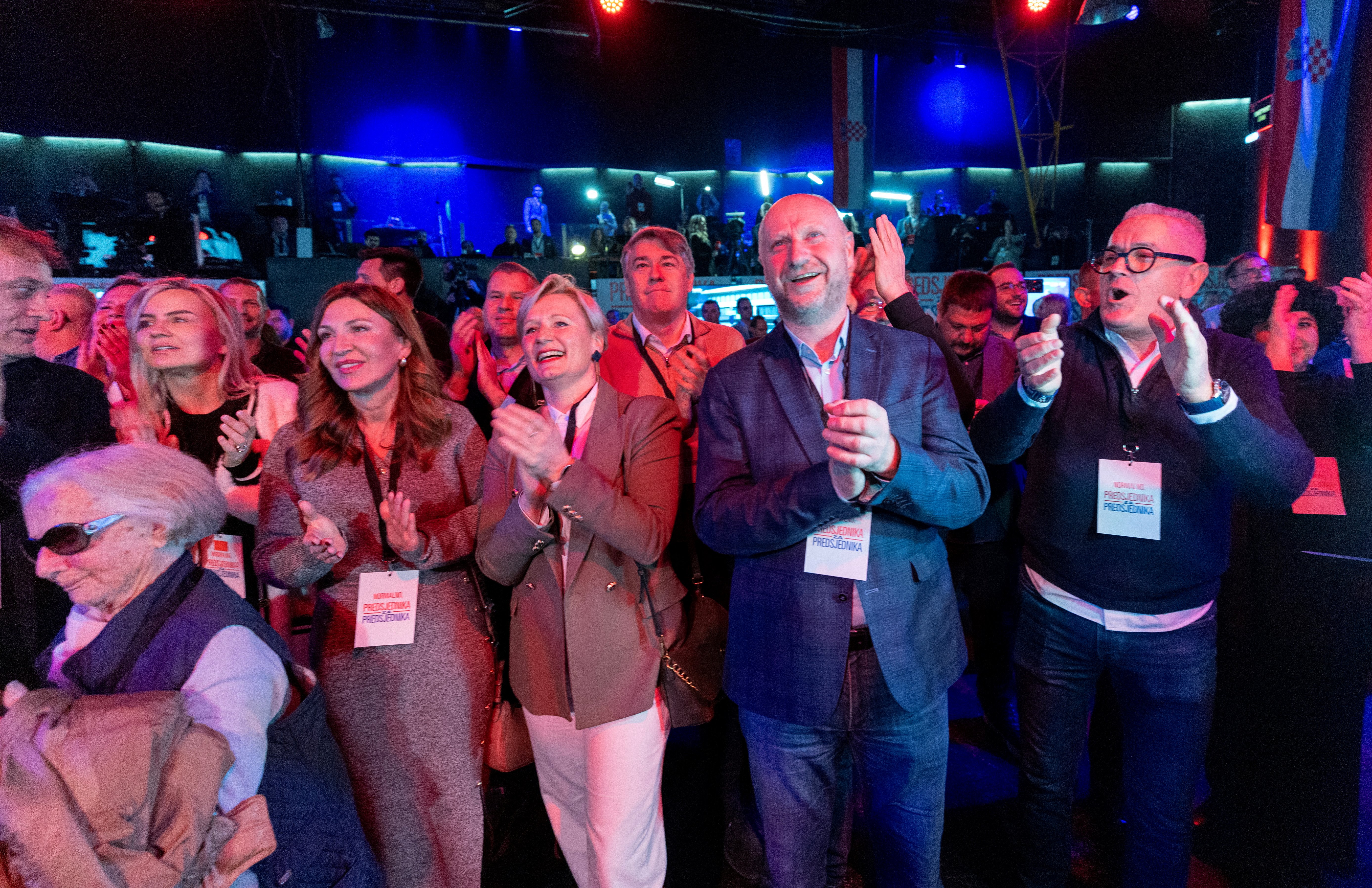 Supporters of Croatia's outgoing President and Social Democratic Party (SDP) presidential candidate Zoran Milanovic celebrate after the first exit poll results at the candidate's headquarters in Zagreb, Croatia, on December 29, 2024. - Croatia's incumbent President, backed by the opposition left-wing Social Democrats, won the presidential election in the first round, according to an exit poll. (Photo by DAMIR SENCAR / AFP)