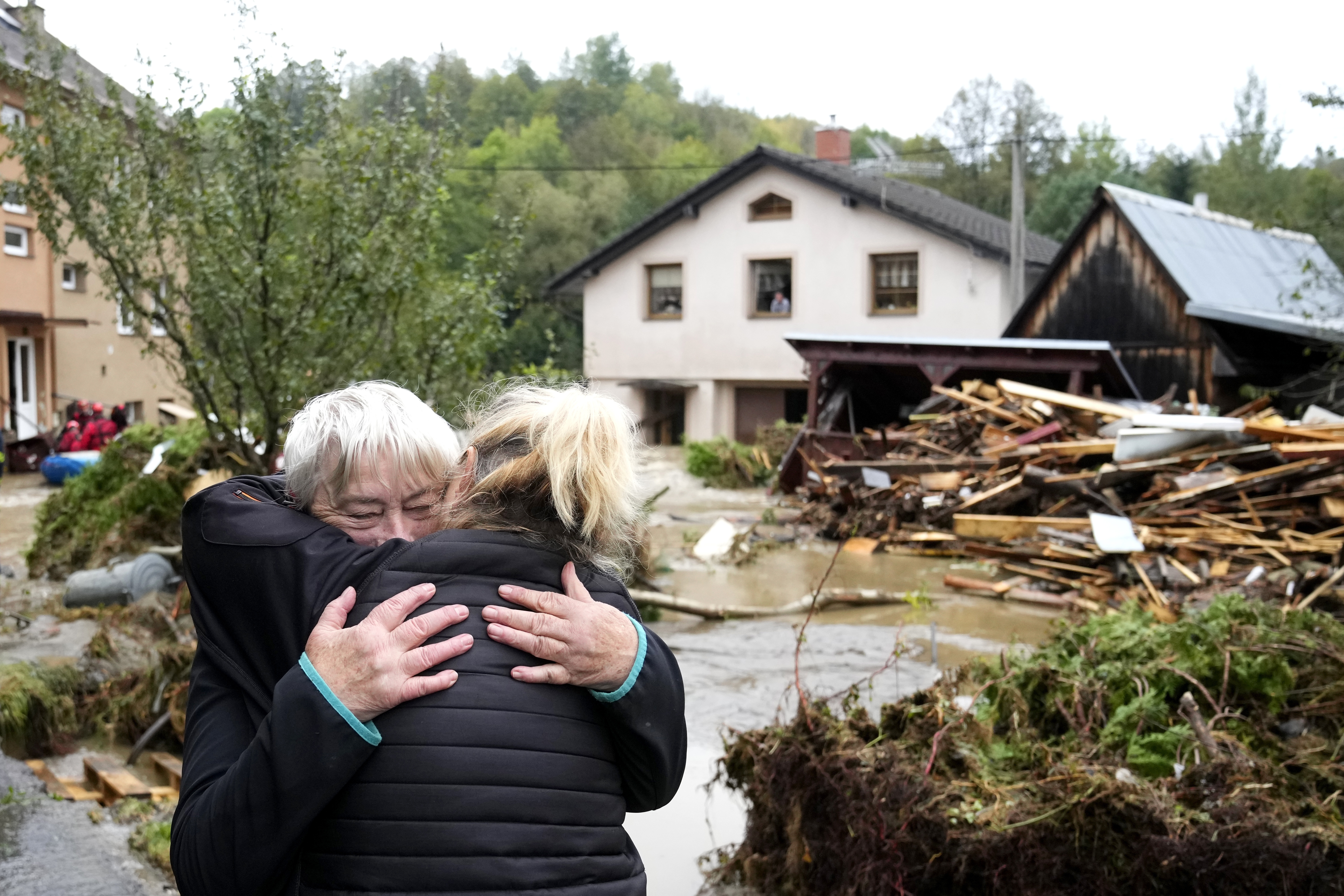 A resident hugs her relative after being evacuated from her flooded house in Jesenik, Czech Republic, Sunday, Sept. 15