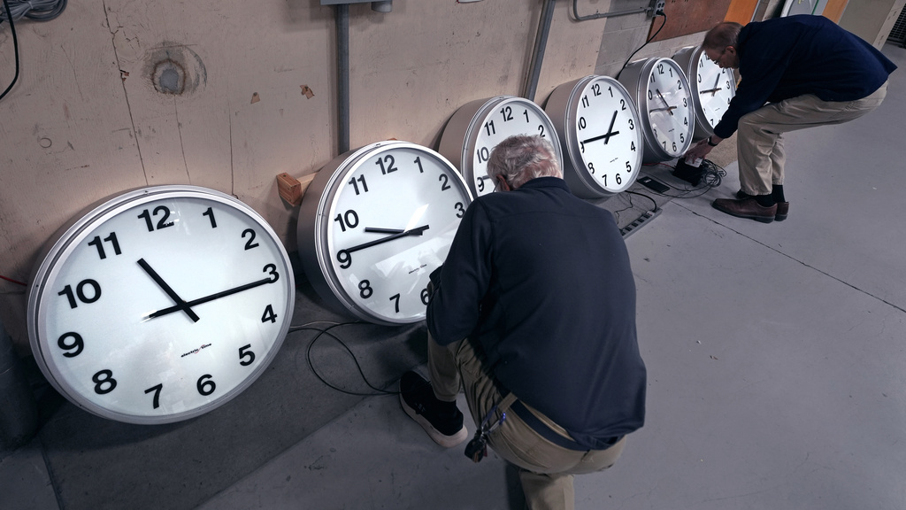 A man works on clocks