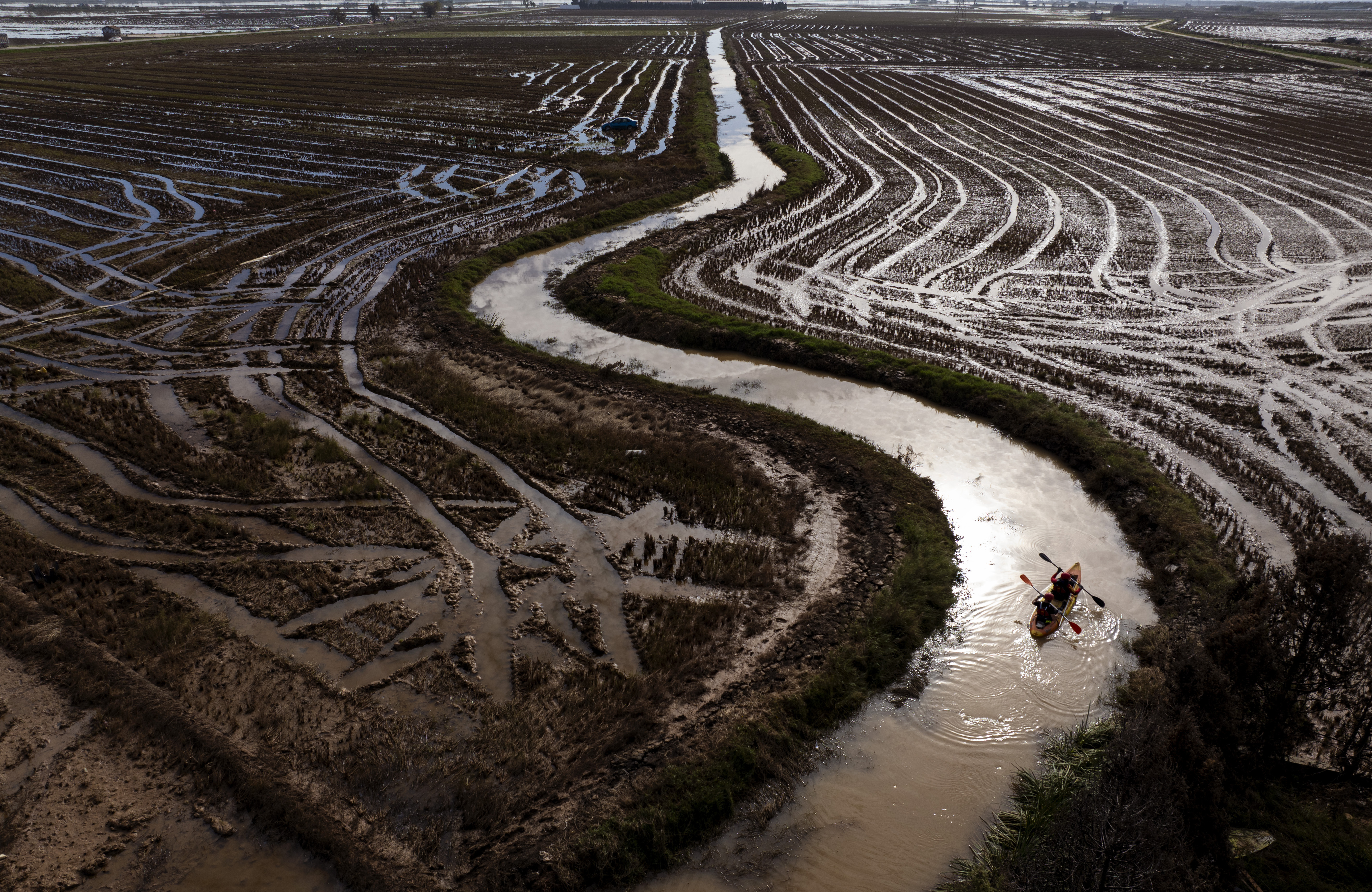 Members of the V battalion of the military emergency unit, UME, use a canoe to search the area for bodies washed away by the floods in the outskirts of Valencia, Spain, Friday, Nov. 8, 2024
